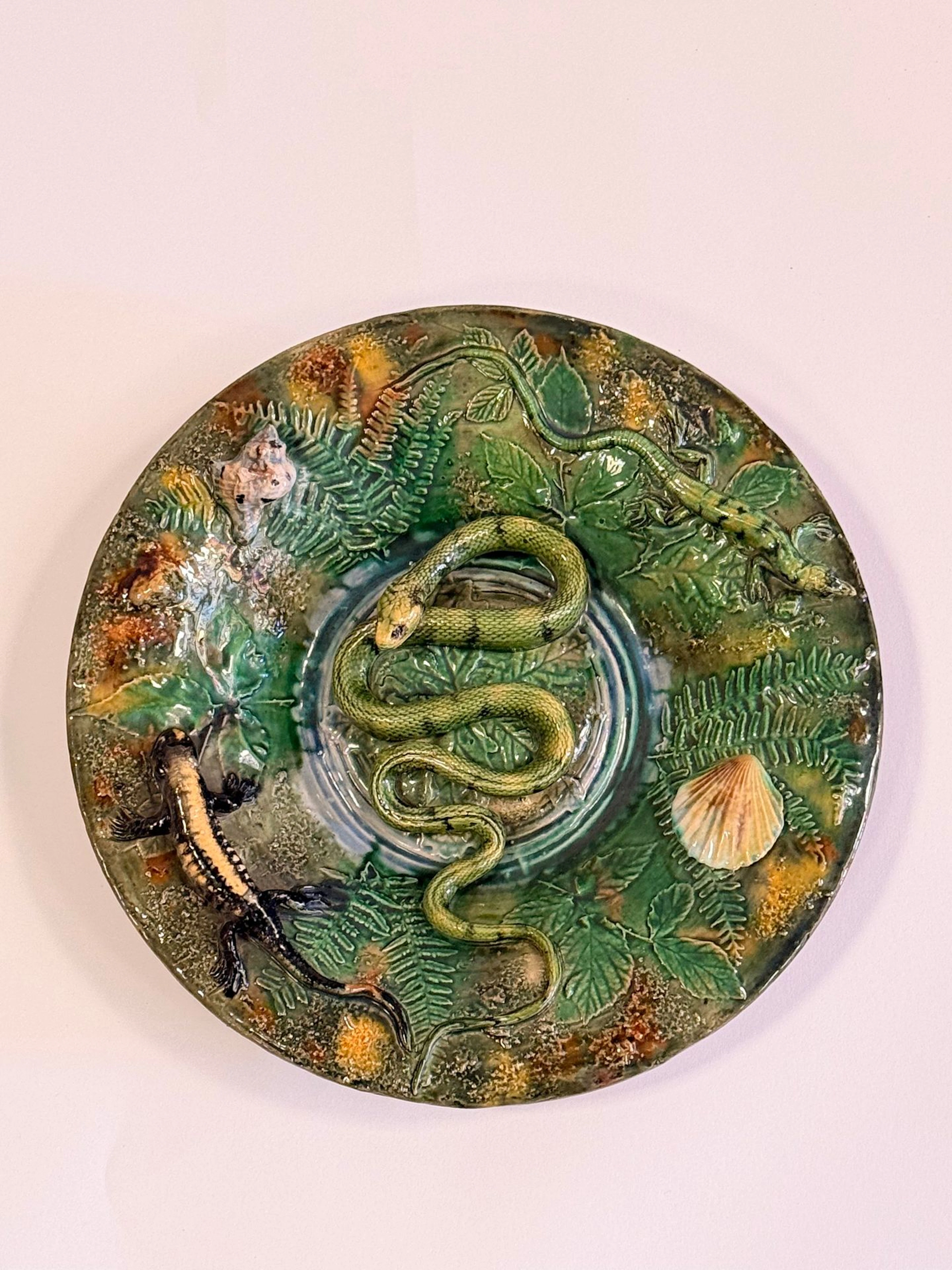 Pair of round earthenware plates with green backgrounds; one - Lot 102