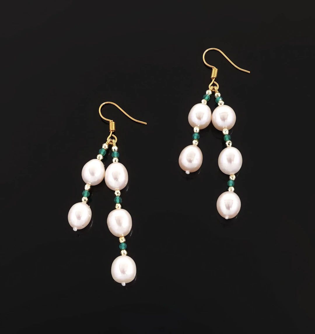 A pair of gold-tone metal earrings adorned with freshwater p - Lot 67