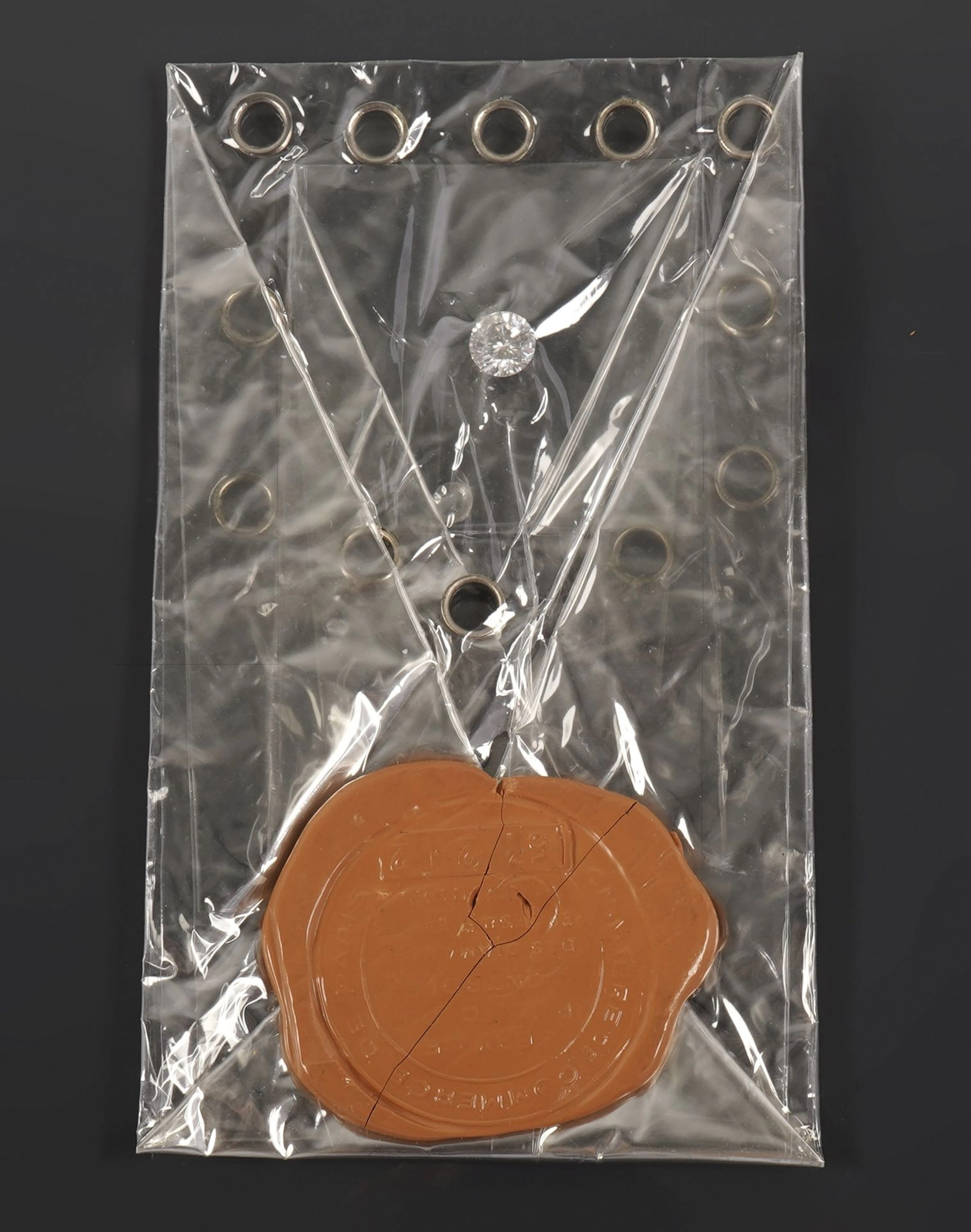 A 1.18-carat round brilliant-cut diamond contained in a seal - Lot 243