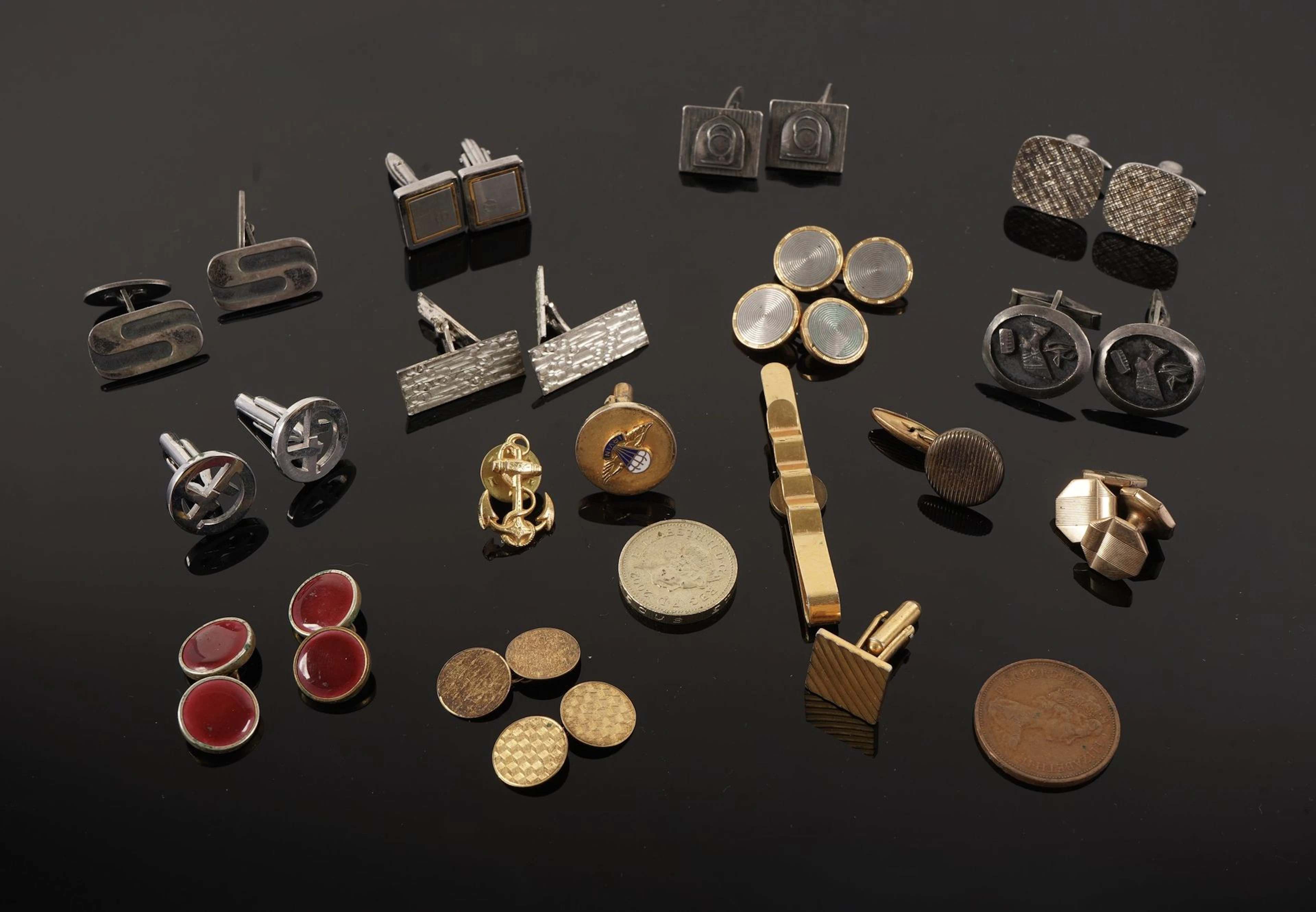 A collection of metal cufflinks in various shapes, styles, a - Lot 63