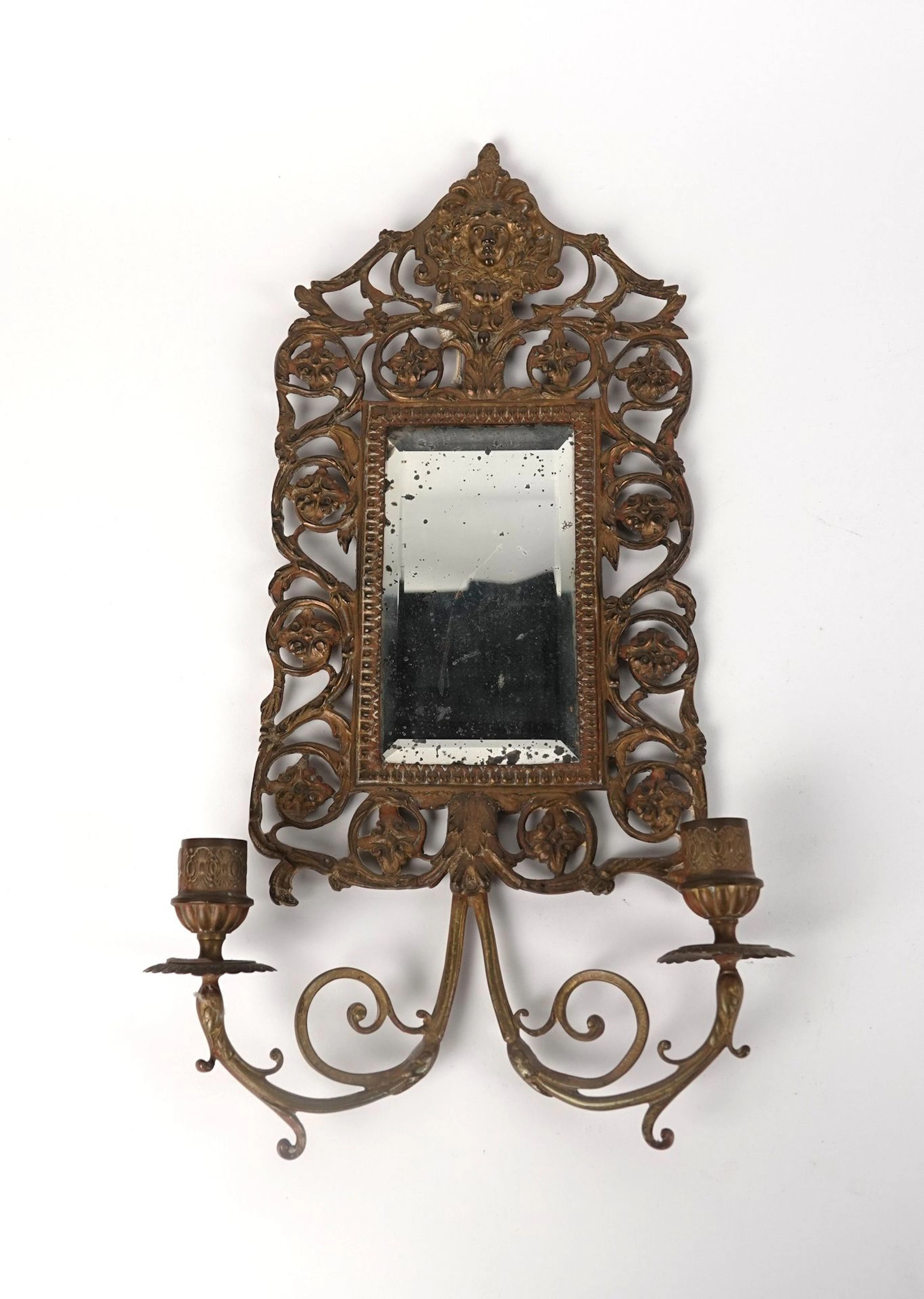 Wall-mounted mirror with two gilded bronze arms, featuring o - Lot 307