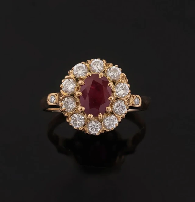 18k yellow gold (750) daisy ring set with an oval-cut ruby s - Lot 291