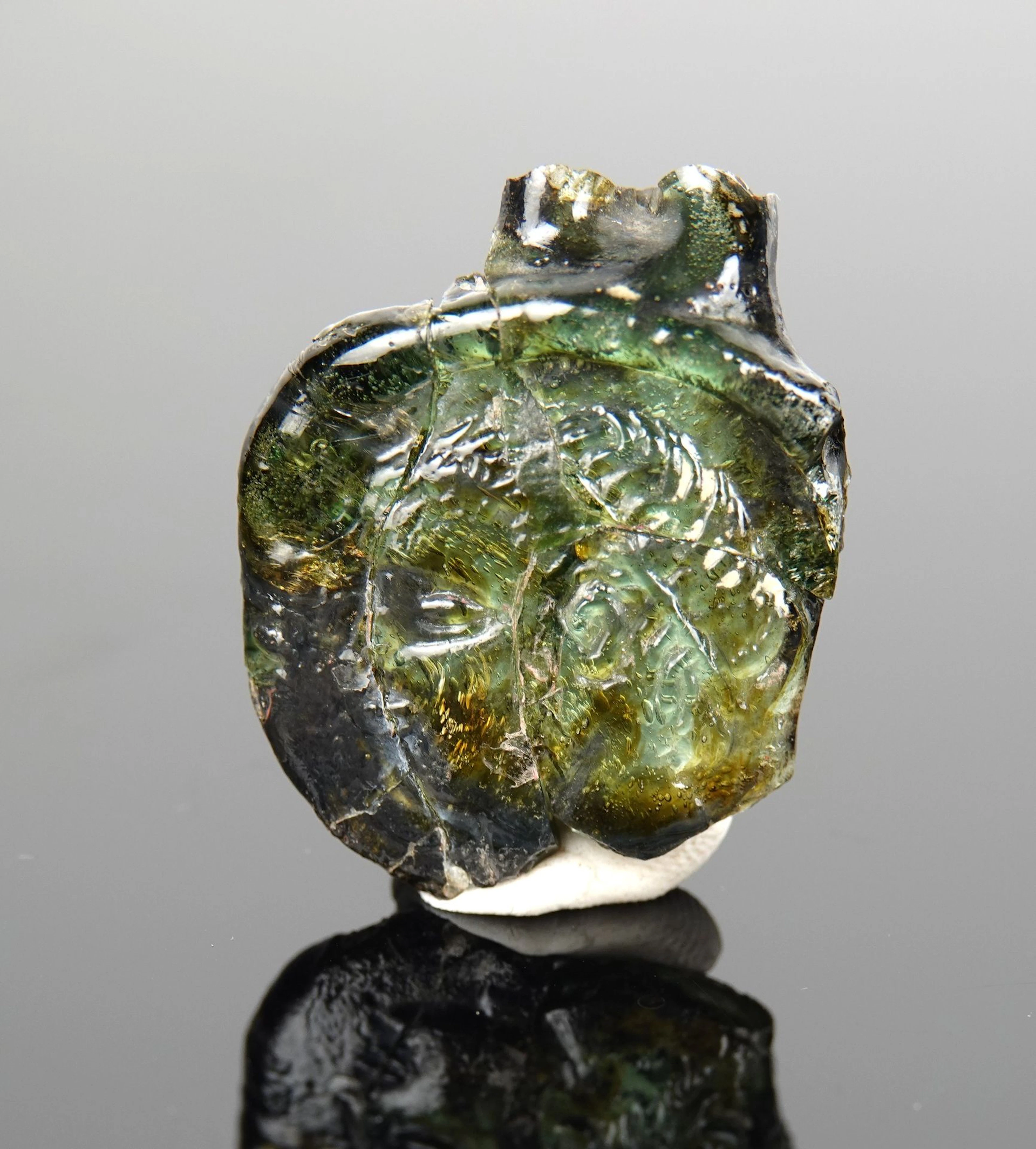 Seal depicting a figure wearing a headband, facing left; a s - Lot 273