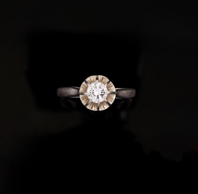 An 18k gold solitaire ring (750 parts per thousand) set with - Lot 230