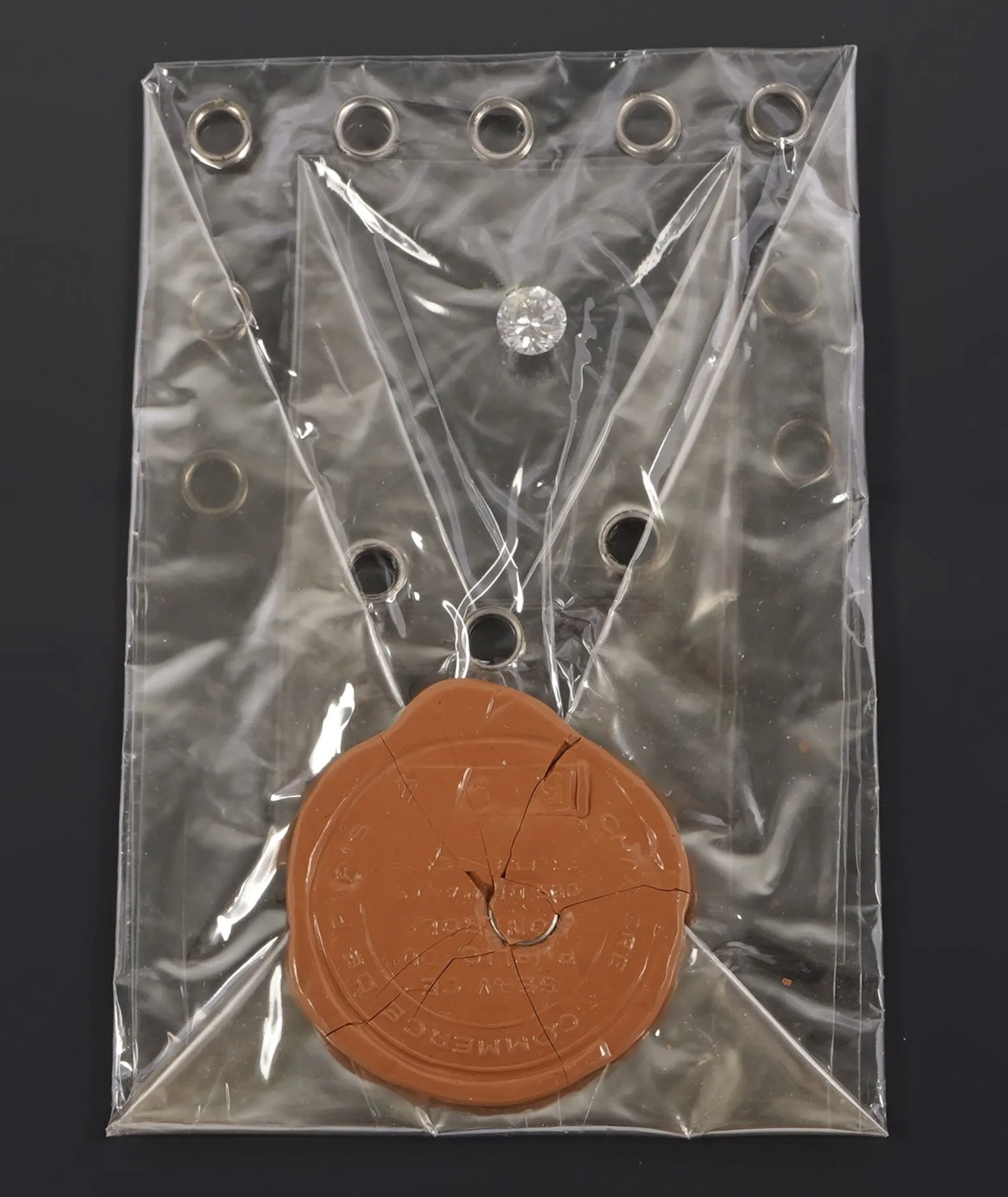 A 1.15-carat round brilliant-cut diamond contained in a seal - Lot 240