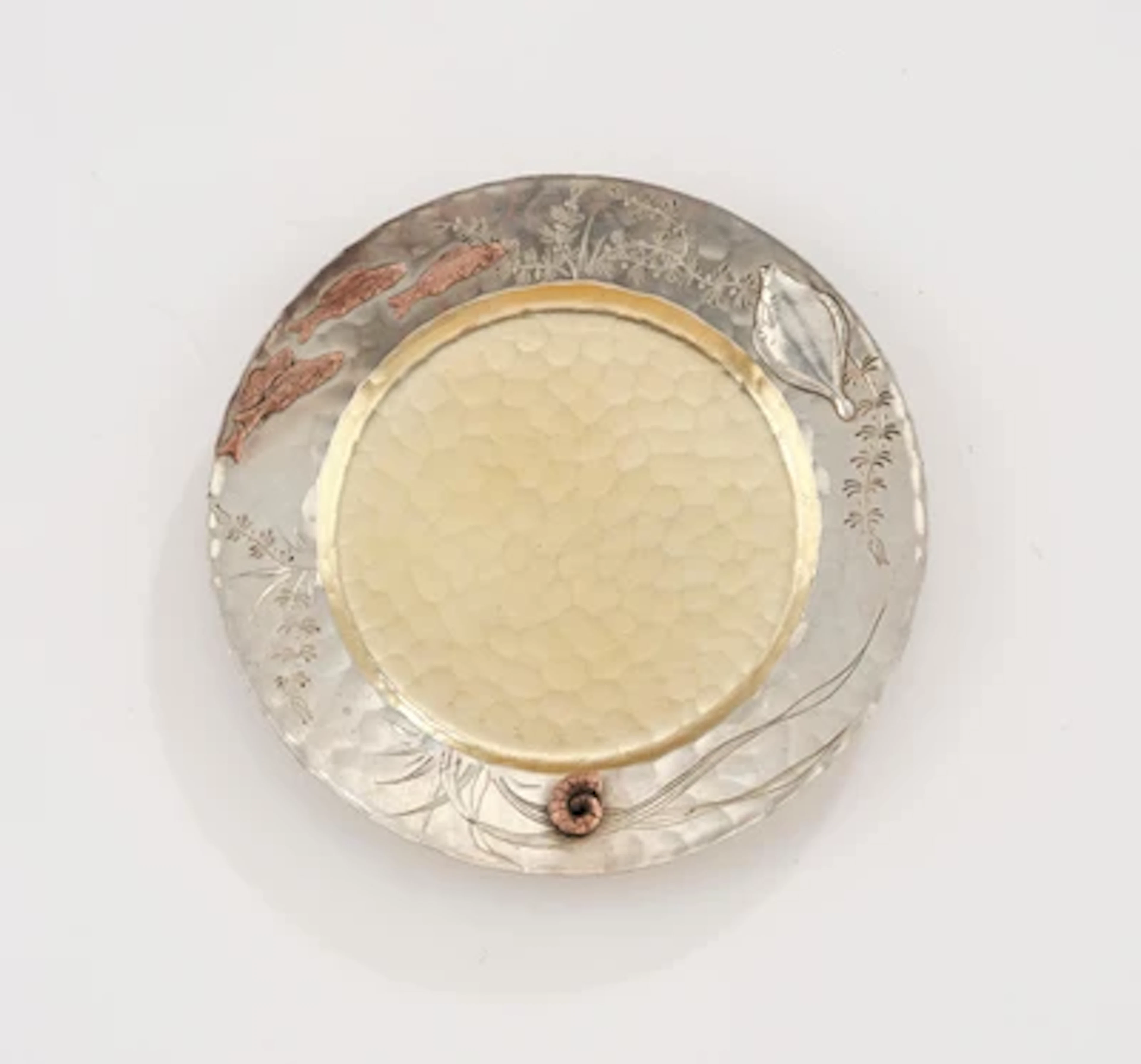 A small sterling silver bowl with fish and underwater decoration
