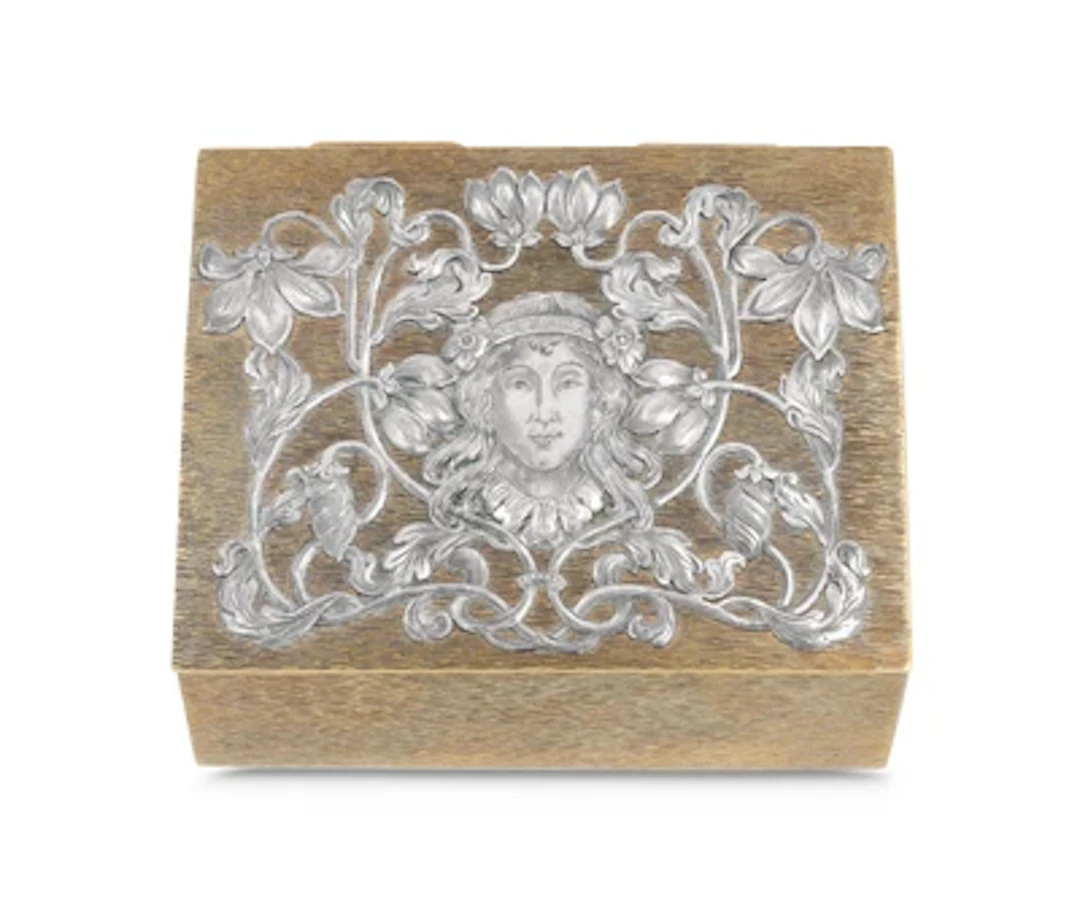 A lidded box with silver-plated mount with a female head and iris
