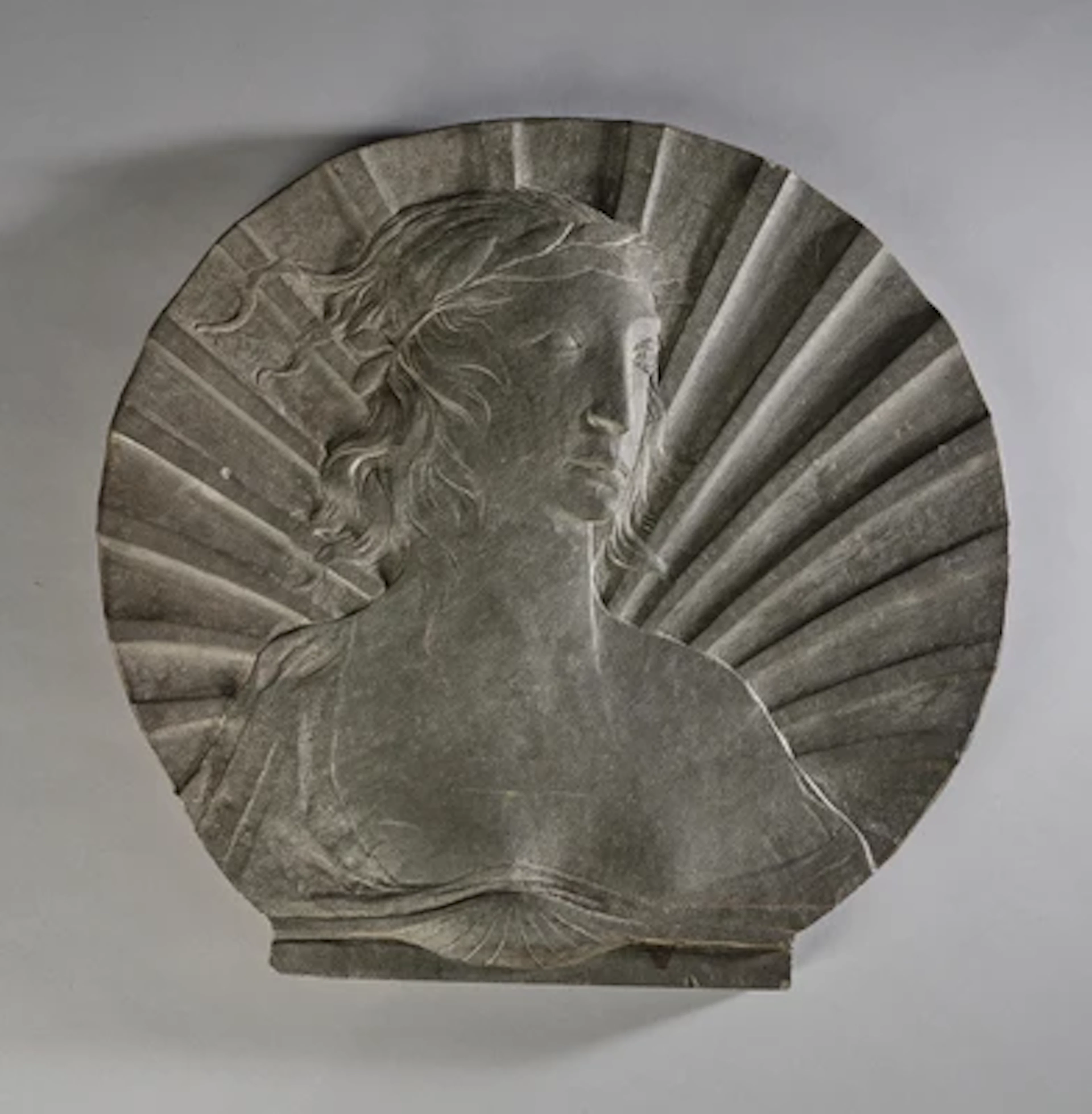 A fan shaped stone relief with a female bust in profile, after Domenico