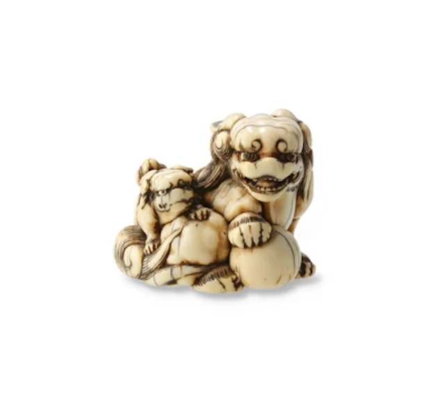 Netsuke eines shishi mit Jungem und Ball, Japan, 19. Jh., signiert