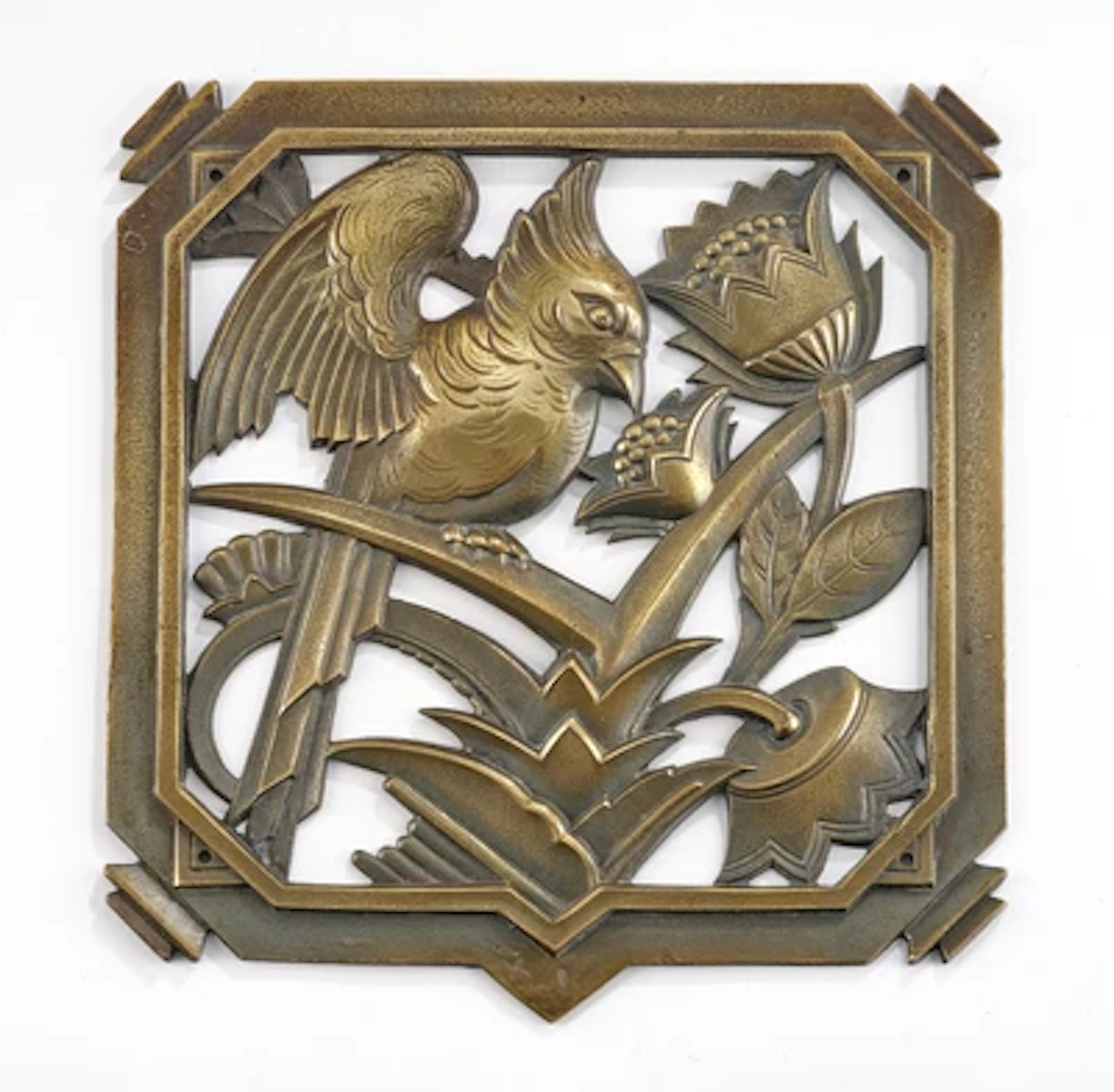 A brass relief, with a parrot and floral motifs, in the manner of