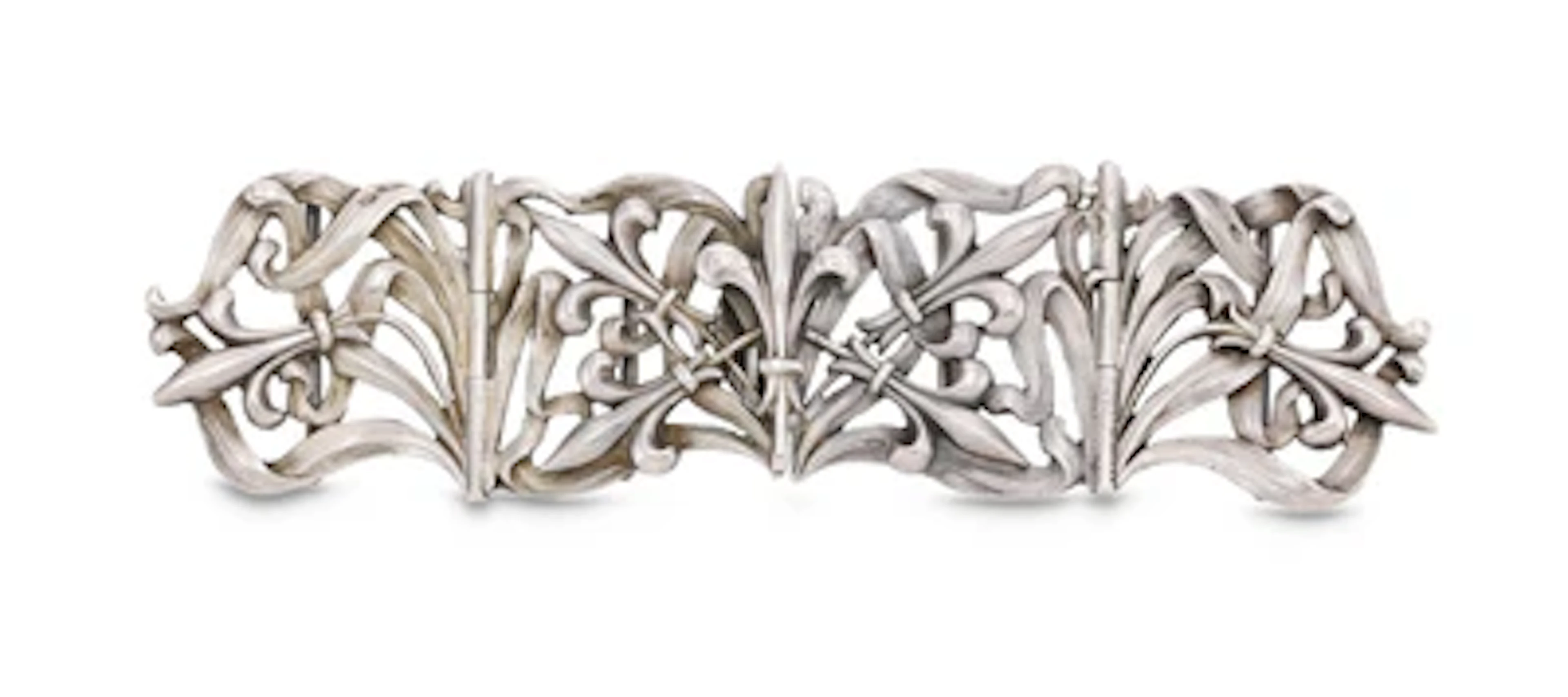 A silver belt buckle with vegetal decoration and fleur-de-lis, Oscar
