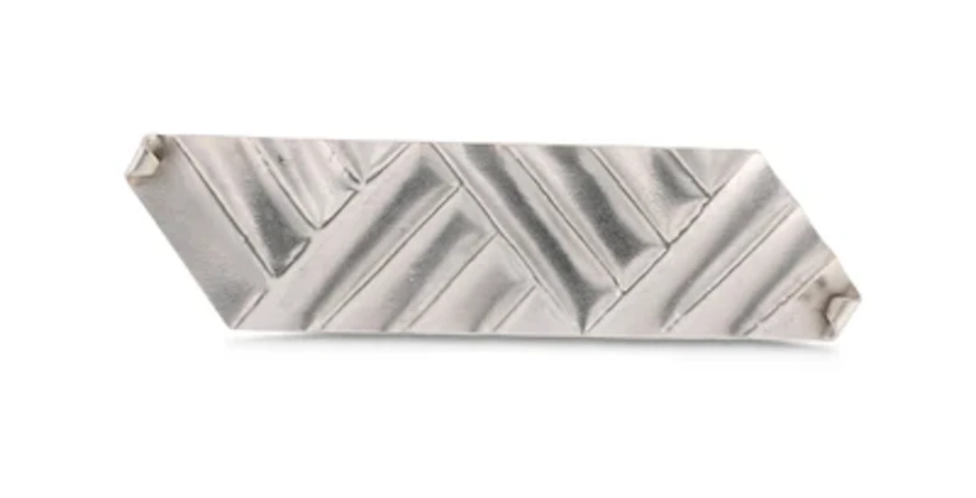 A silver brooch with geometric decoration