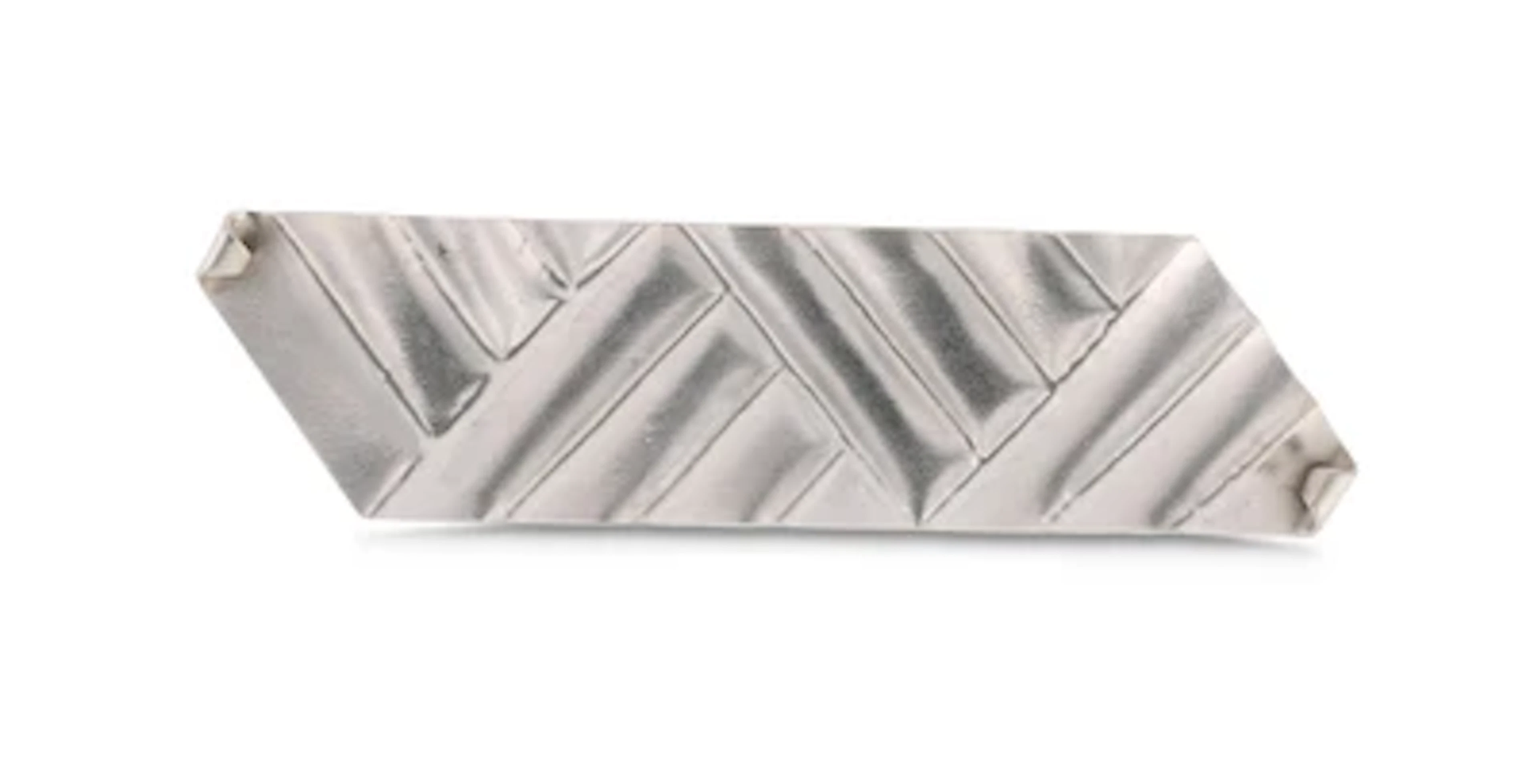 A silver brooch with geometric decoration