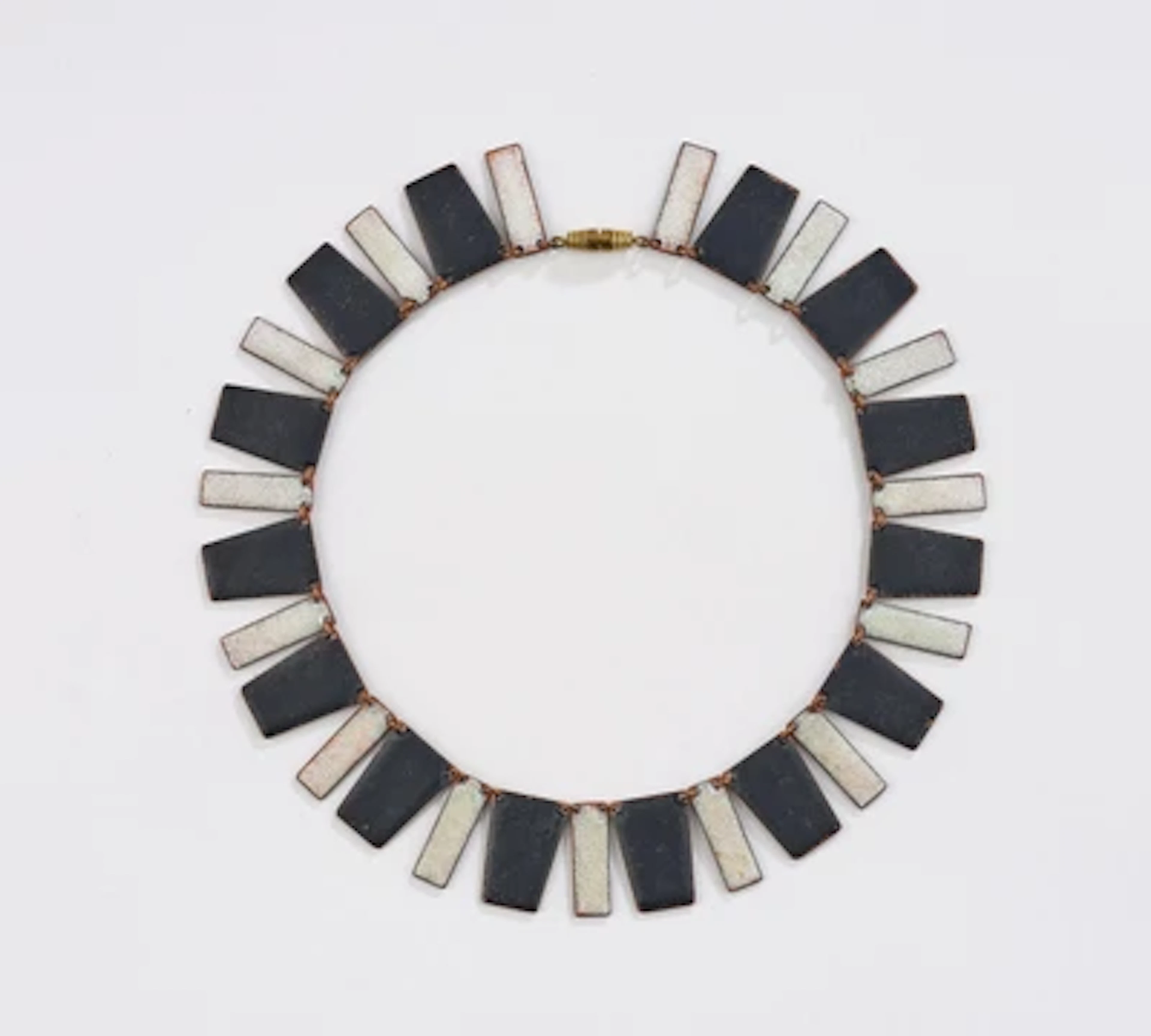 A necklace with black and white enamelling in the manner of Albert