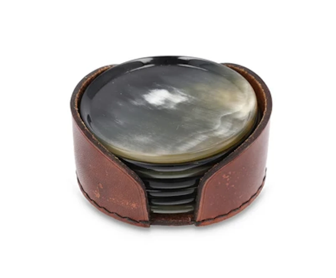 Seven horn coasters in a leather case, model number 4704, Carl Auböck