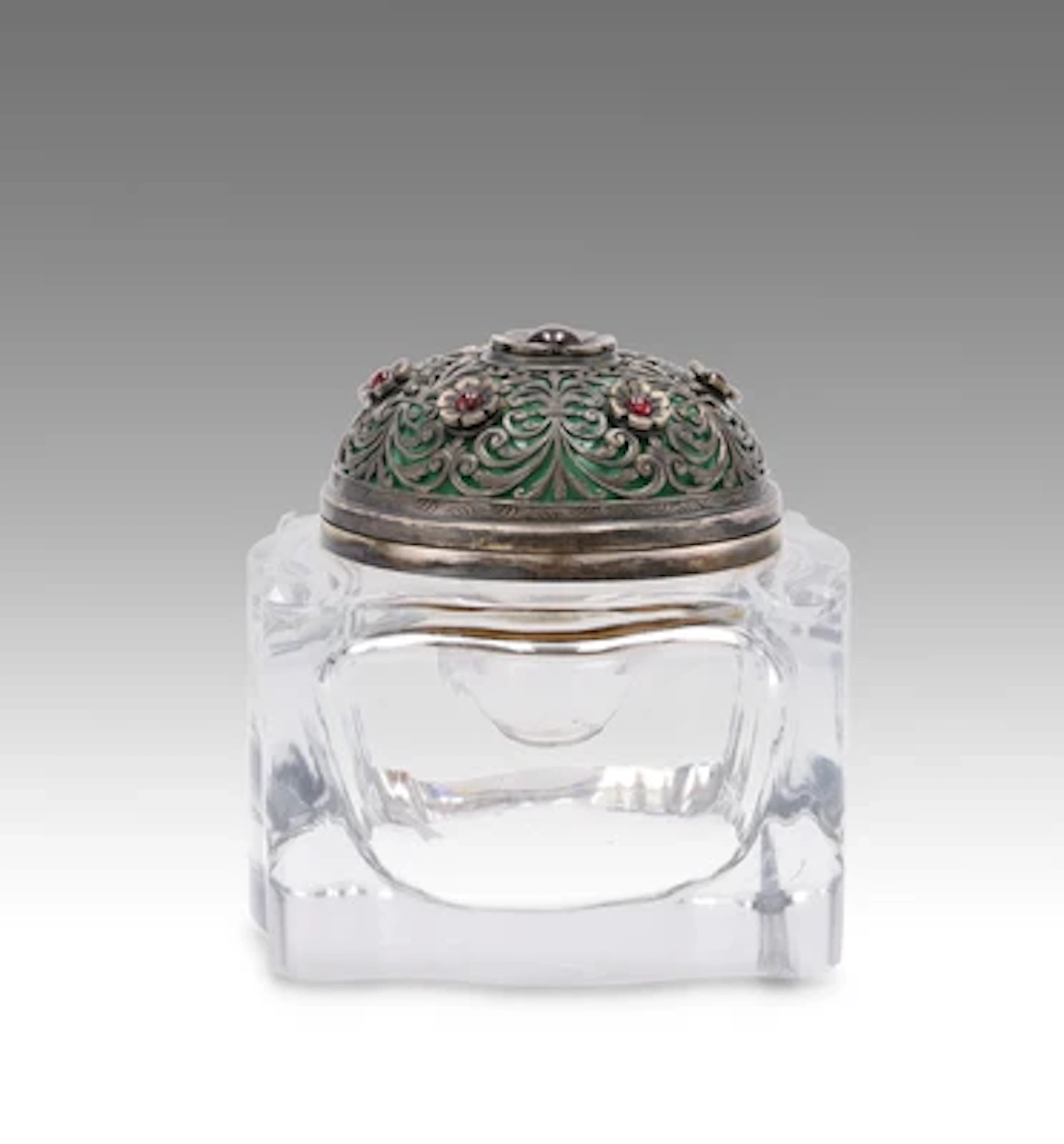 An inkwell with silver mount decorated with enamelling and garnets