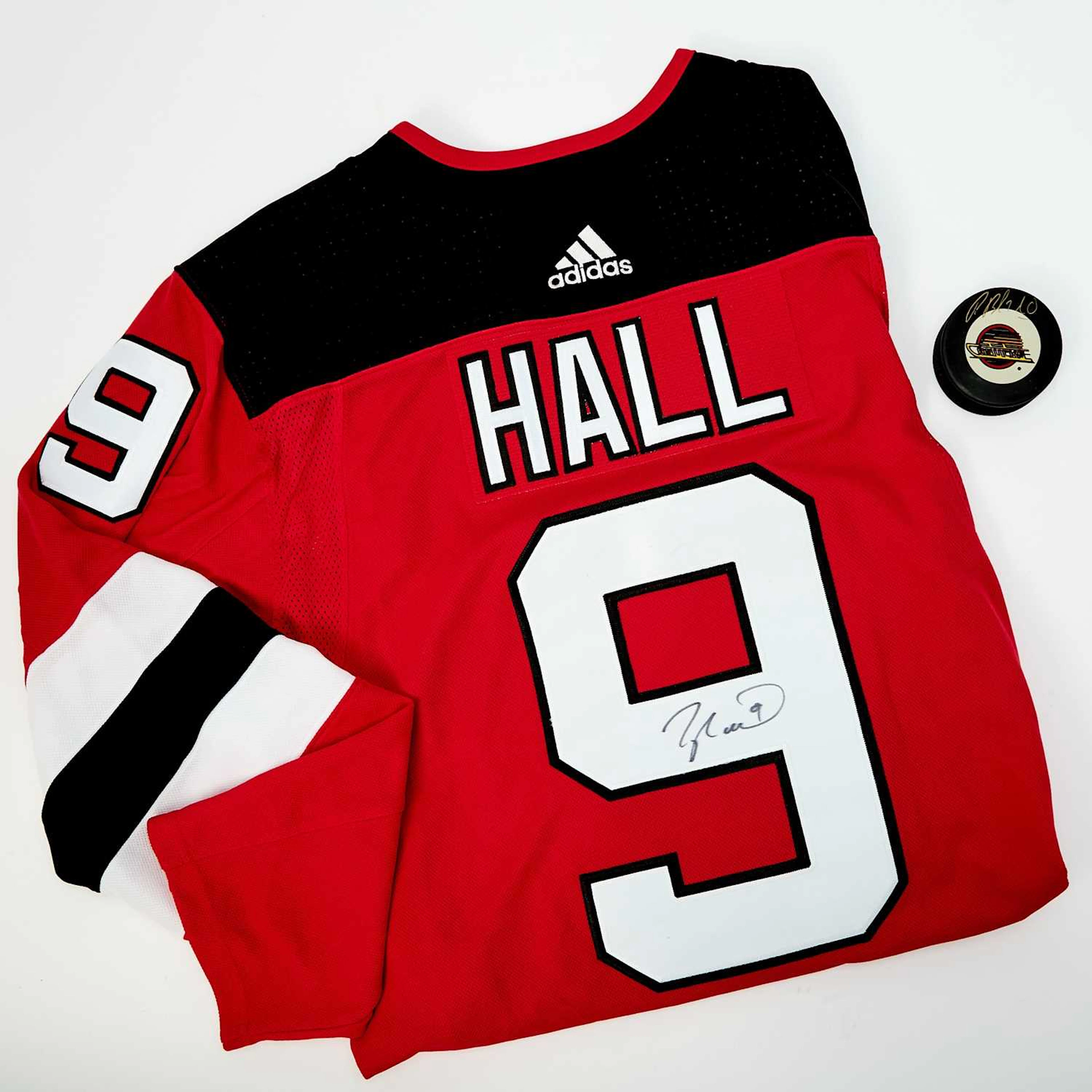 NJ Devils Jersey signed by Taylor Hall, a puck signed by Pavel Bure