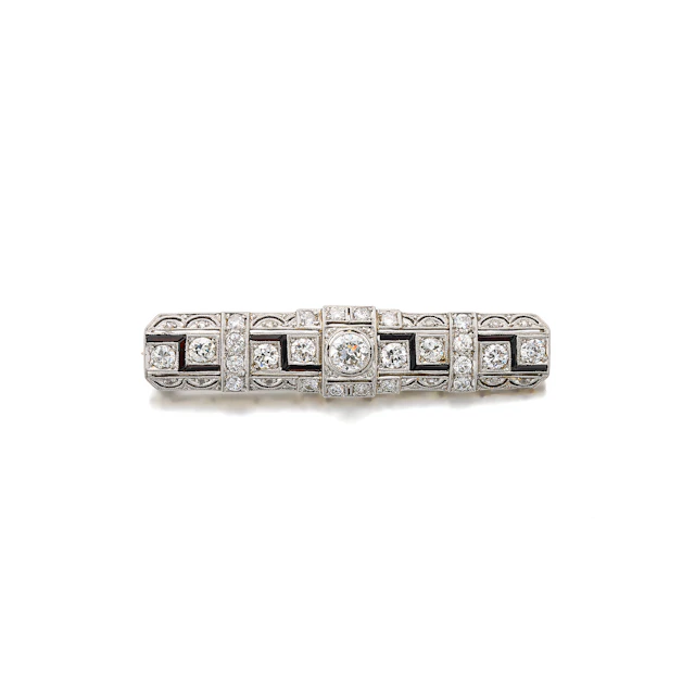 An Art Deco Diamond, Onyx, Platinum and Gold Bar Brooch, circa 1925