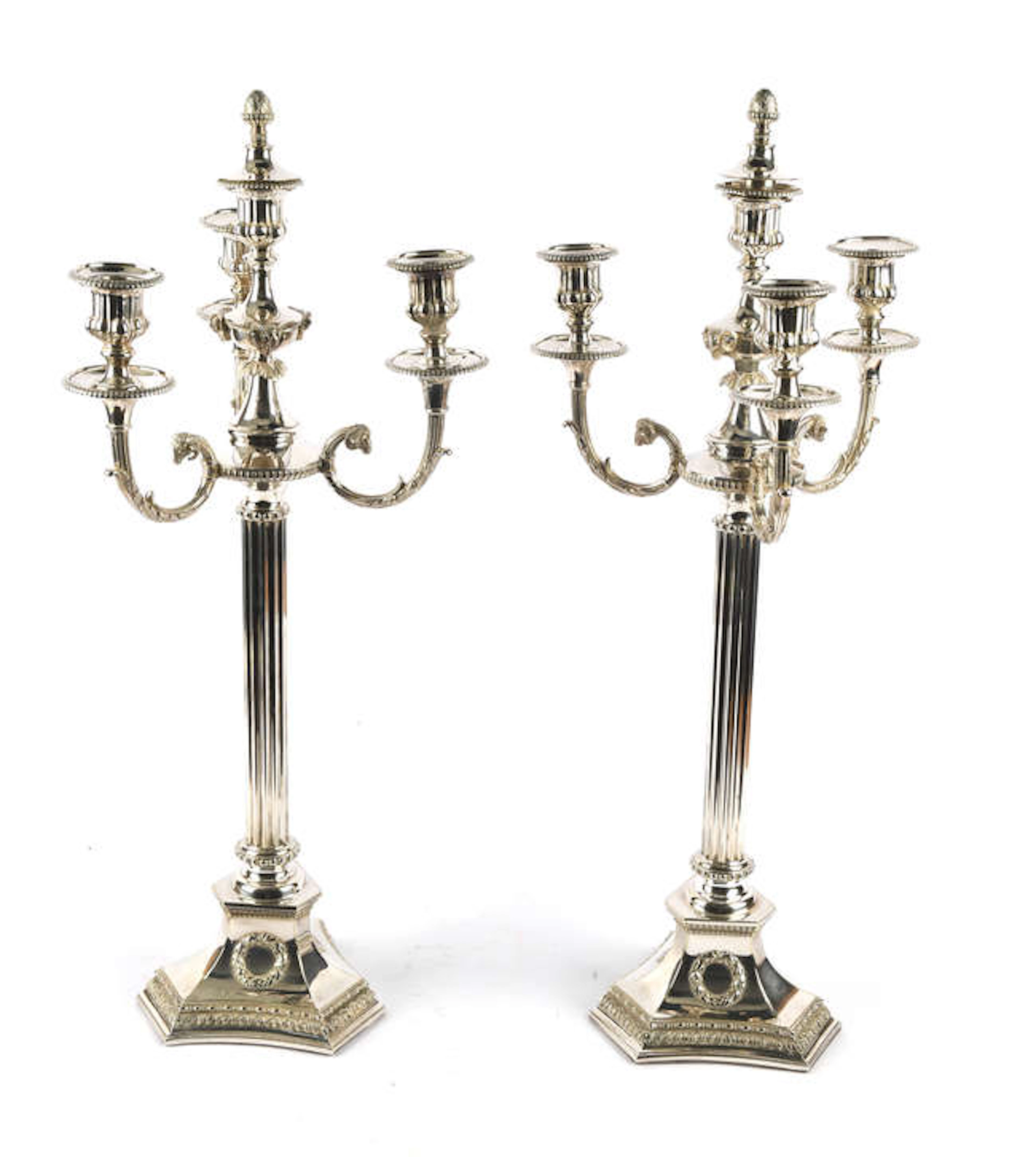 A tall pair of silver plated four light candelabra, with rams head