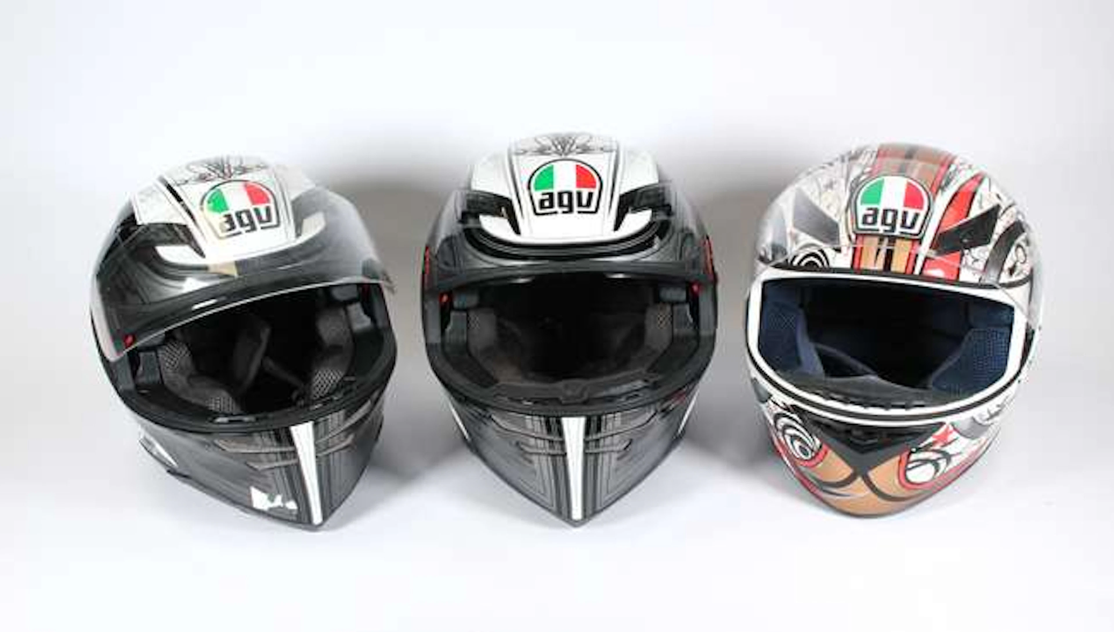 3 AGV Italian Motorcycle Helmets. 2 with AGV rider intercoms and with