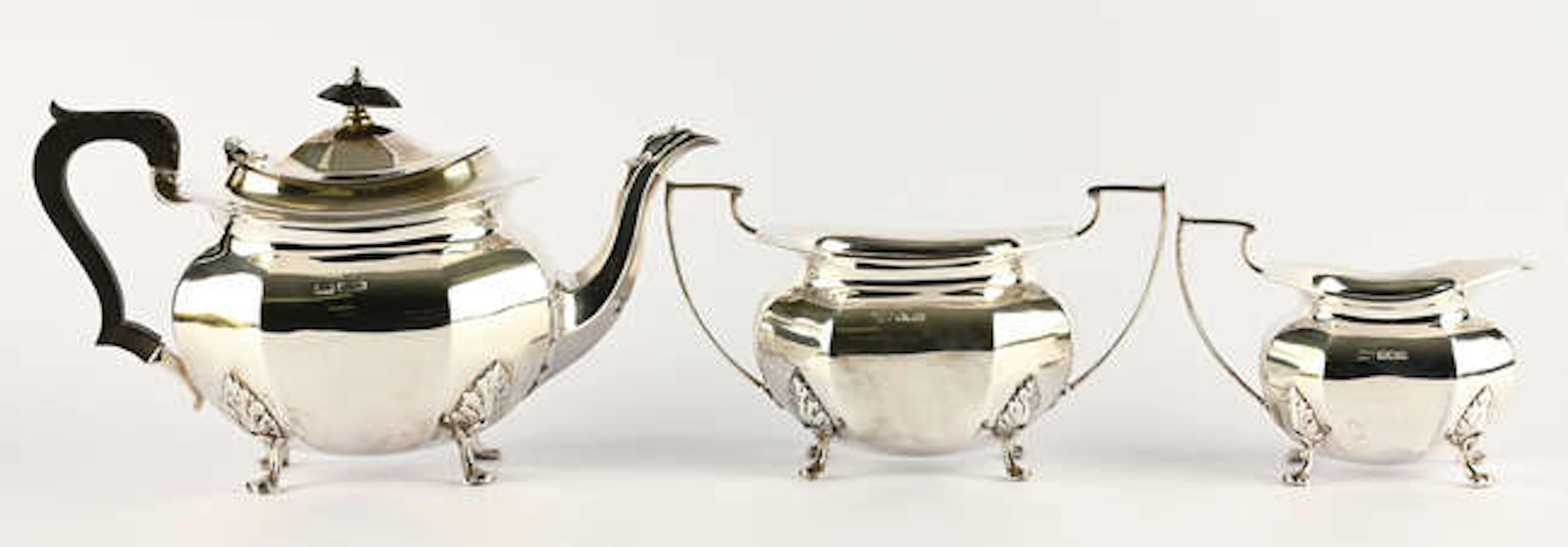 Three piece tea service of octagonal form, on acanthus capped paw