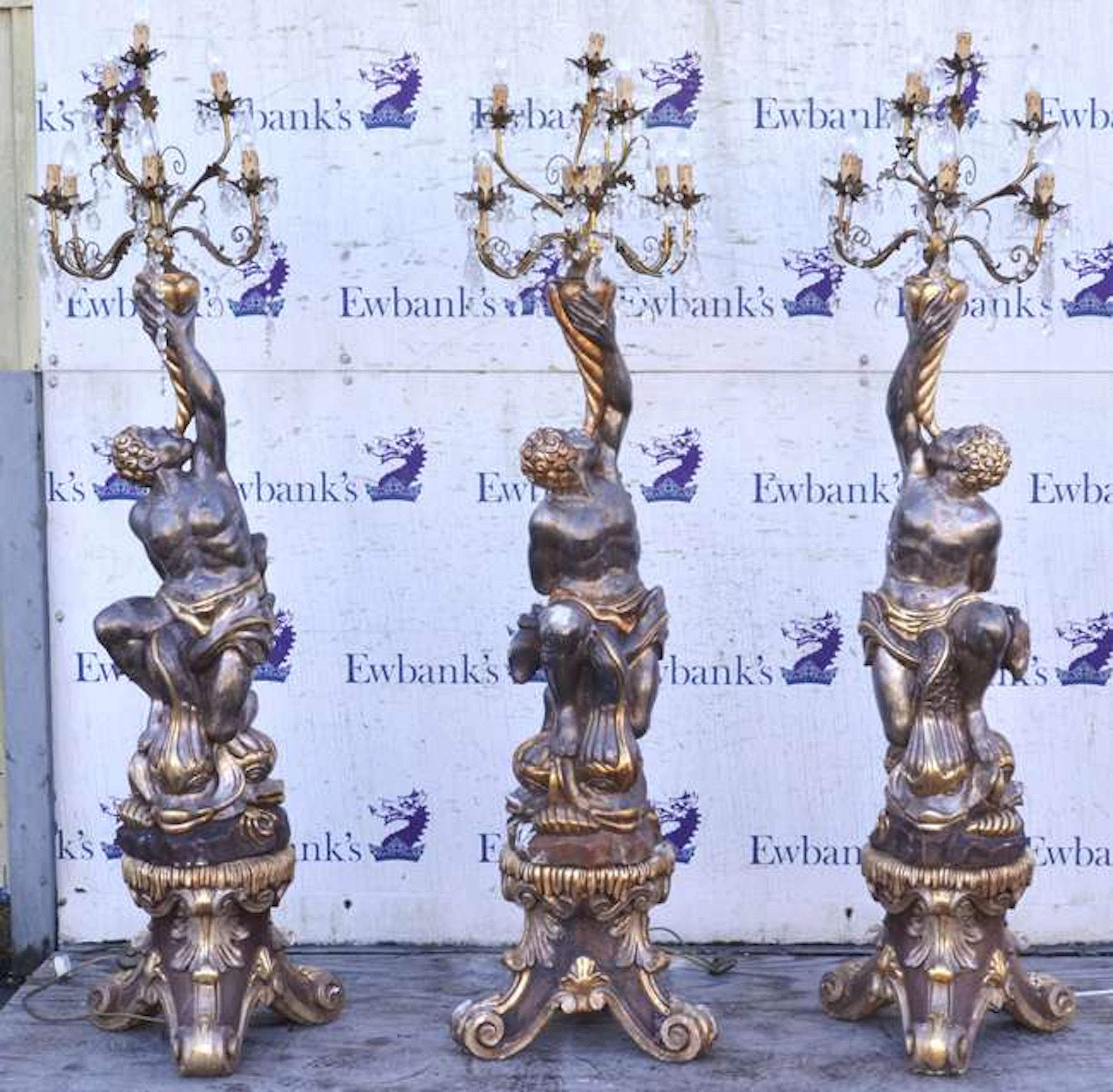 A pair of modern silvered carved wood figural chandeliers, each set