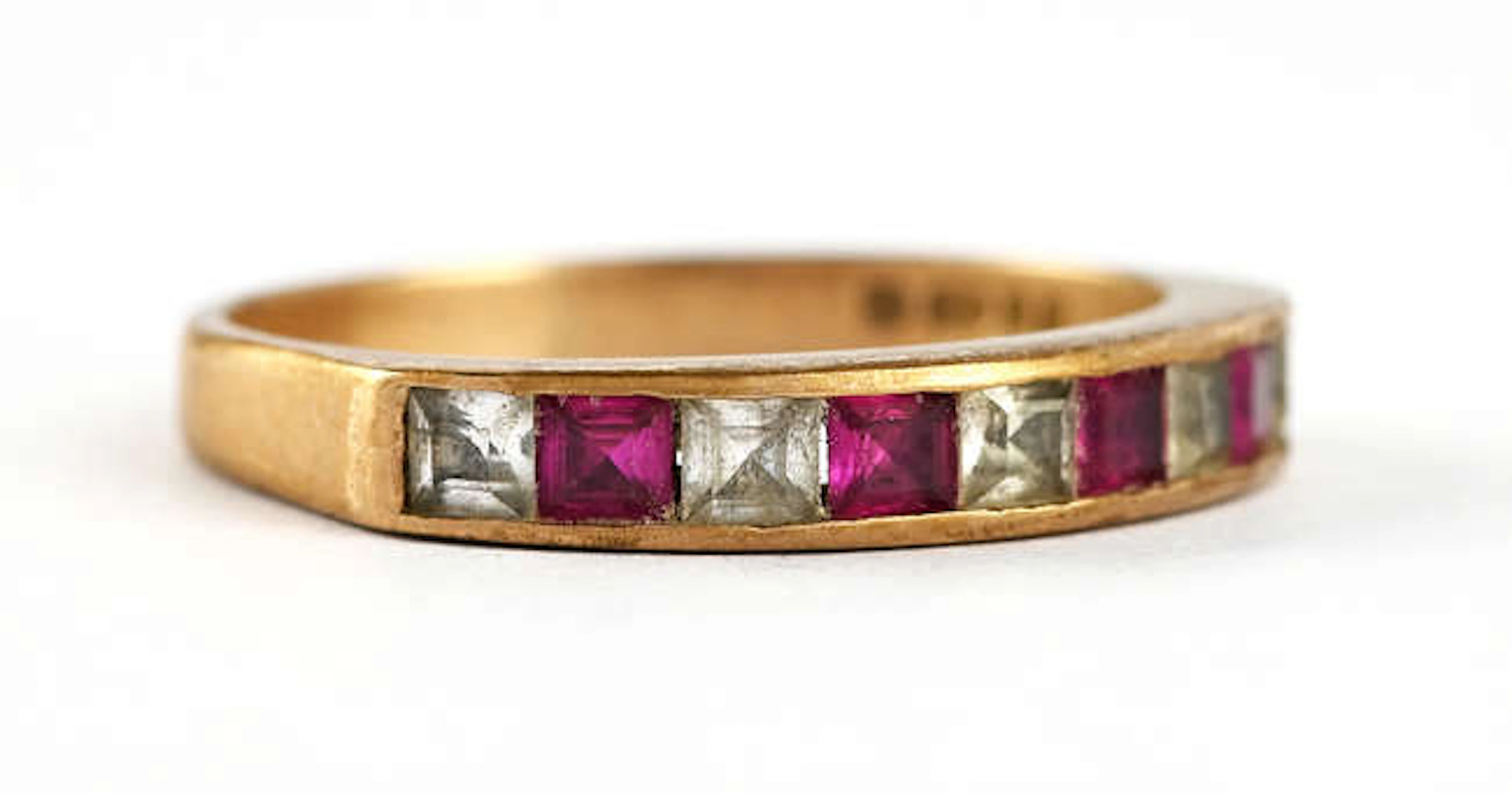 Synthetic ruby and paste half eternity ring, set with nine step cut