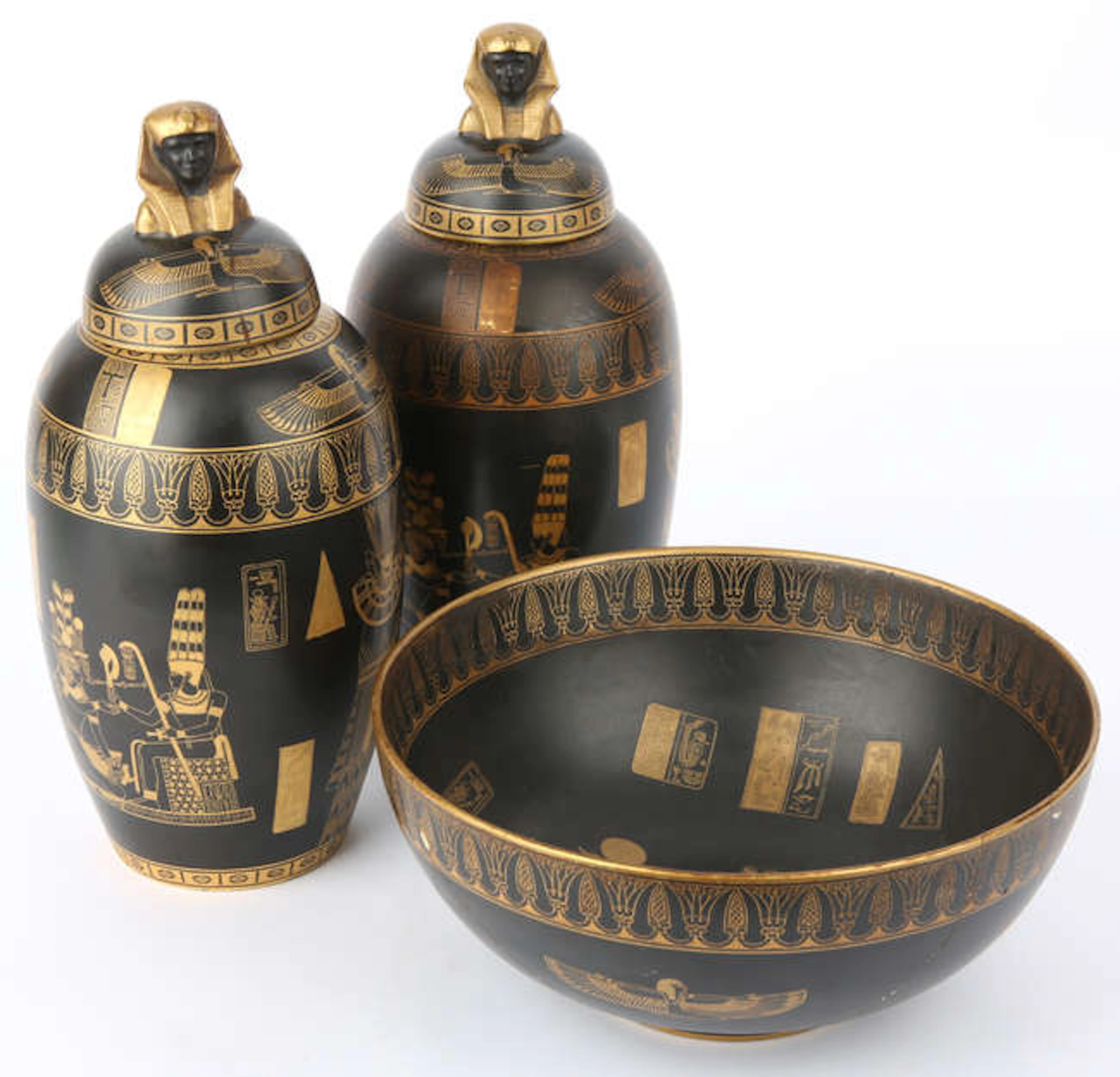 CARLTONWARE, a pair of Tutankhamun jars and covers, in a black and
