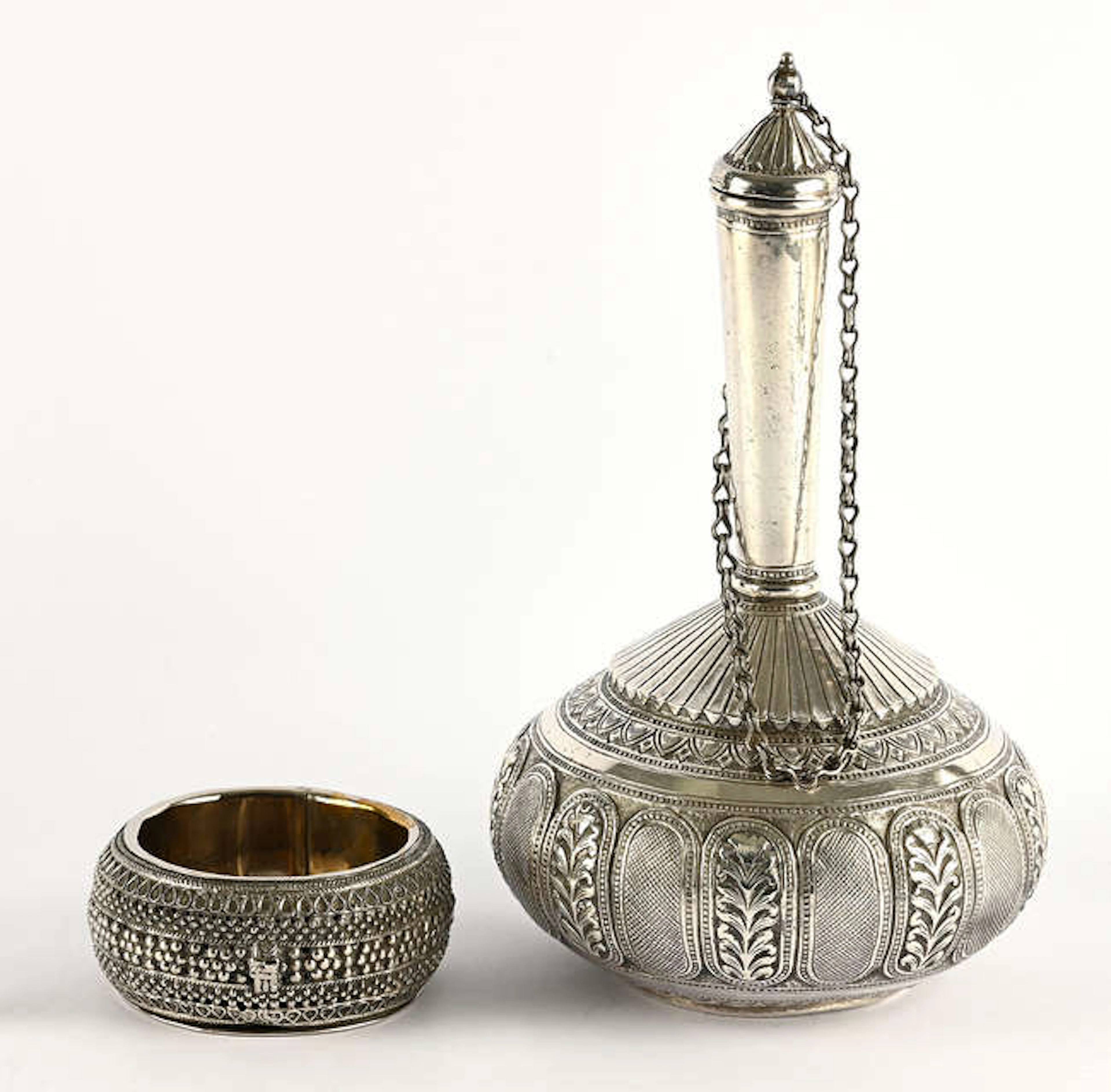 Indian white metal rosewater flask, chased and embossed with foliate