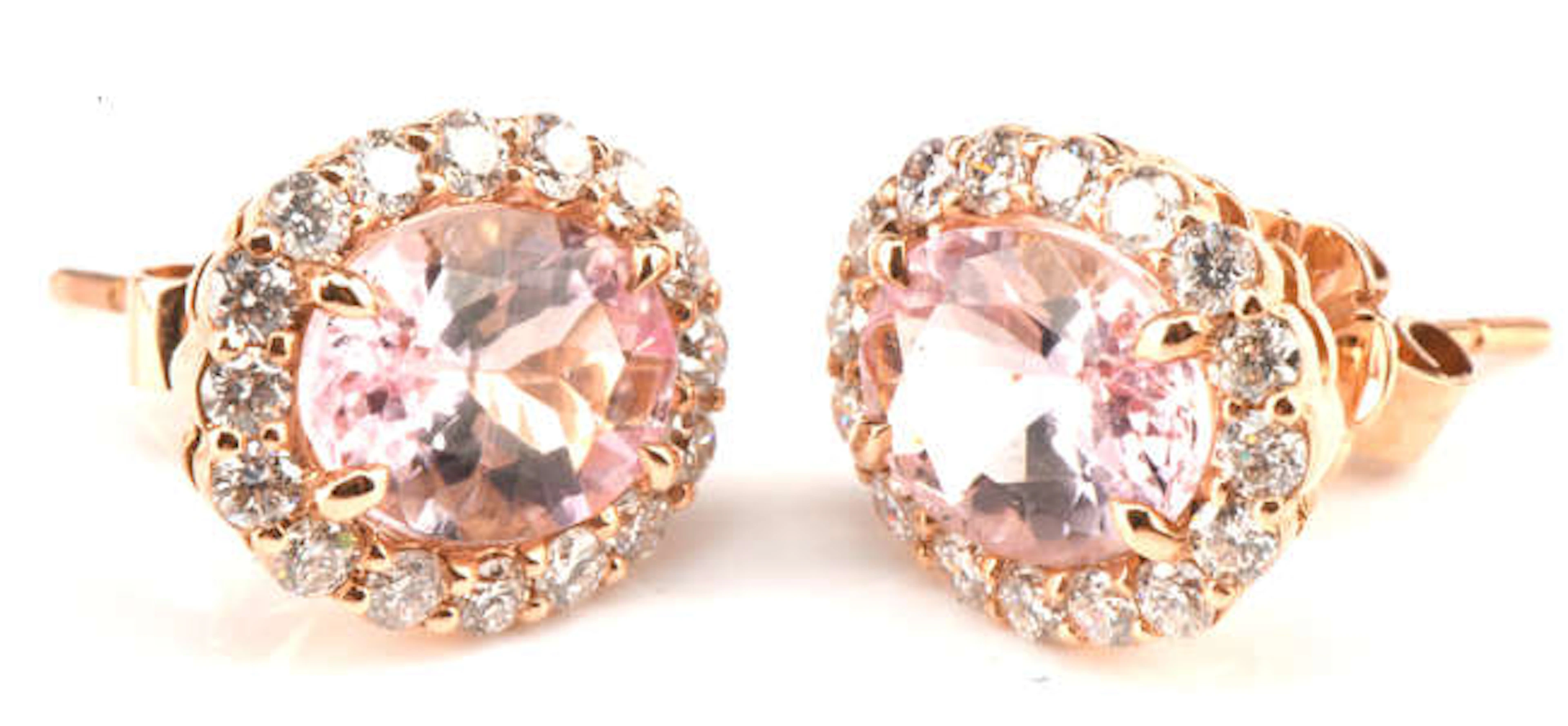 A pair of morganite and diamond cluster earrings, set with oval cut
