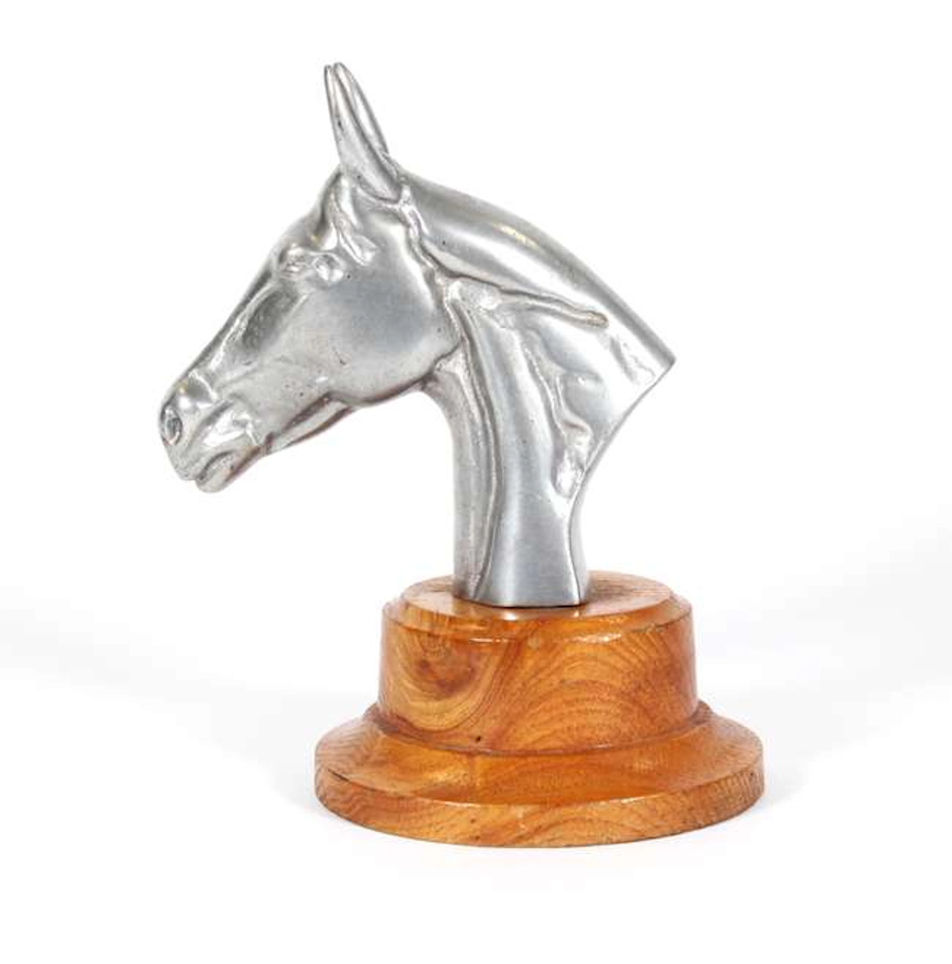 A large horse head car mascot. Mounted on a wooden trophy base. 19cms tall.