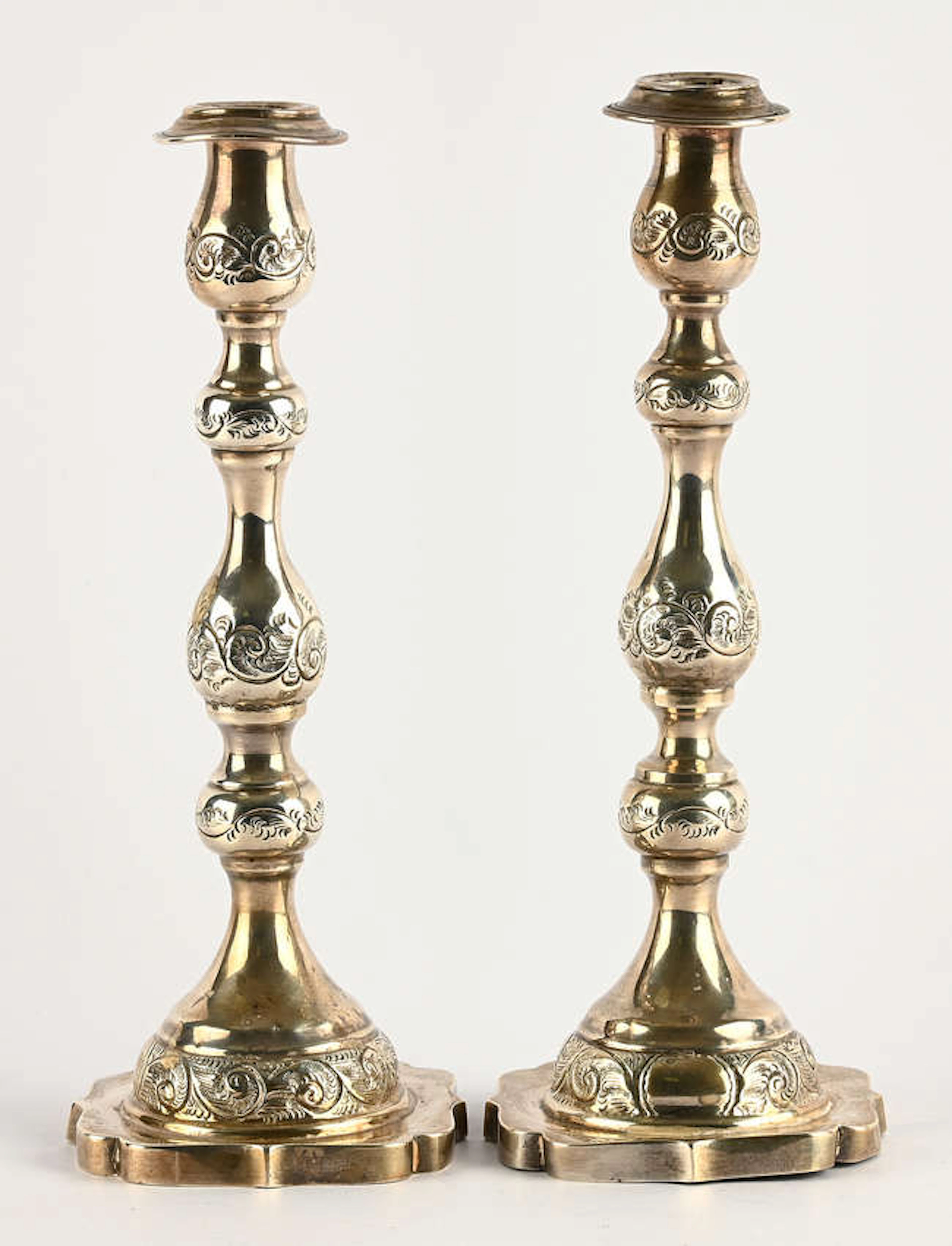 Pair of Shabbat candlesticks, embossed with foliate scrolls, makers