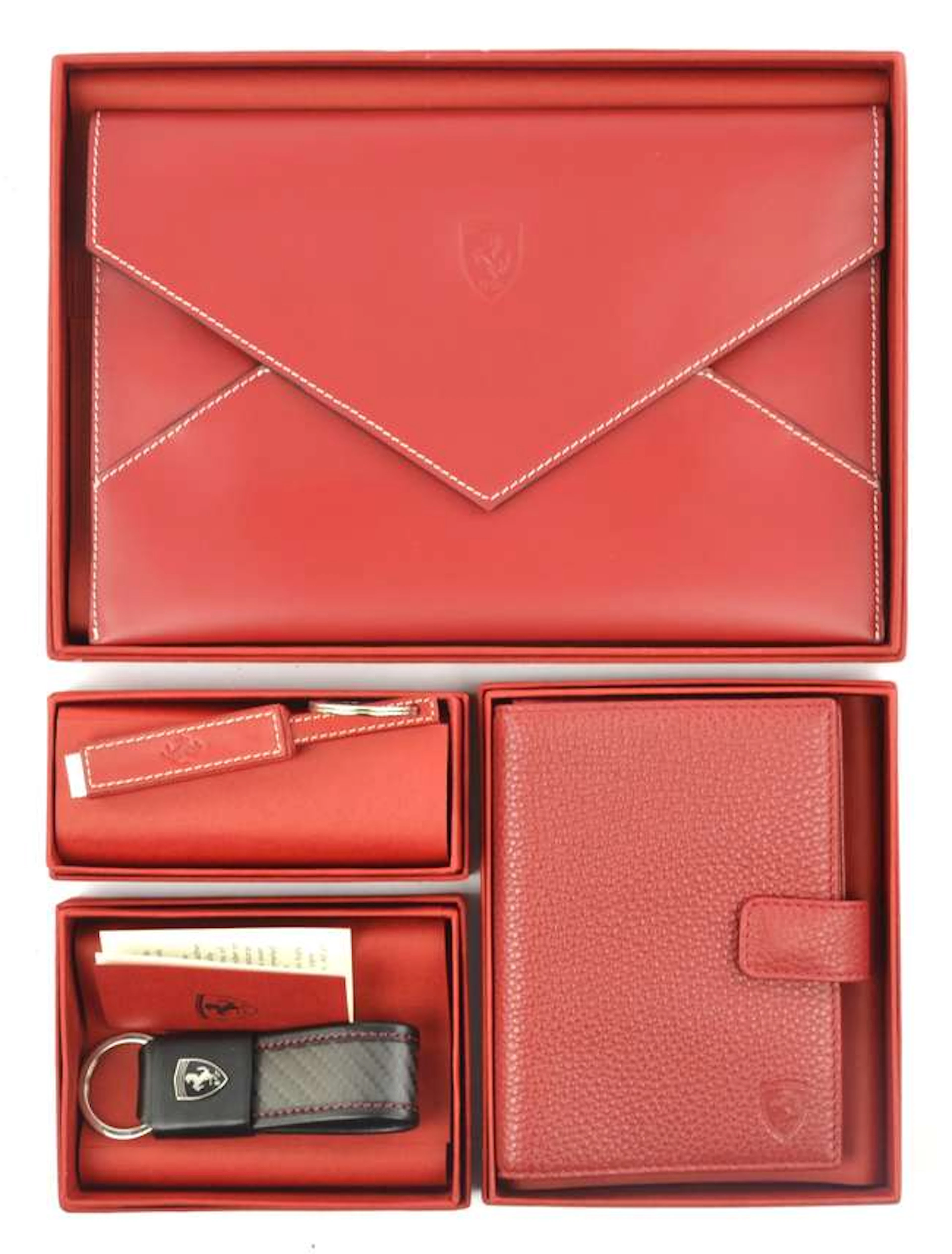 A collection of Official Ferrari products. To include: Red leather