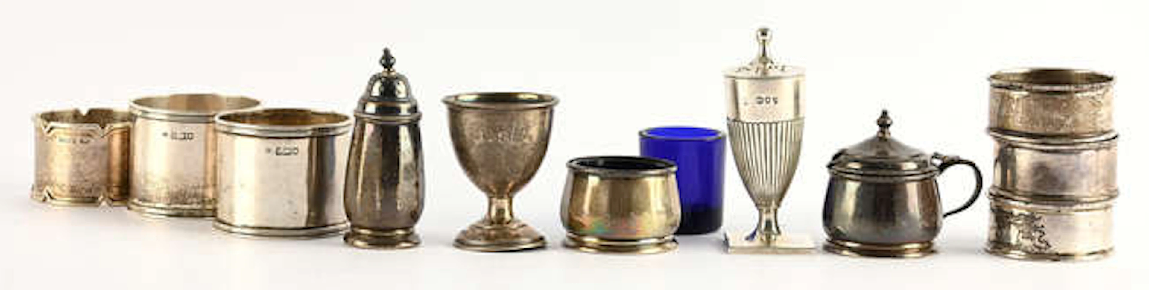 Three piece condiment set, egg cup, and a mixed lot of serviette rings