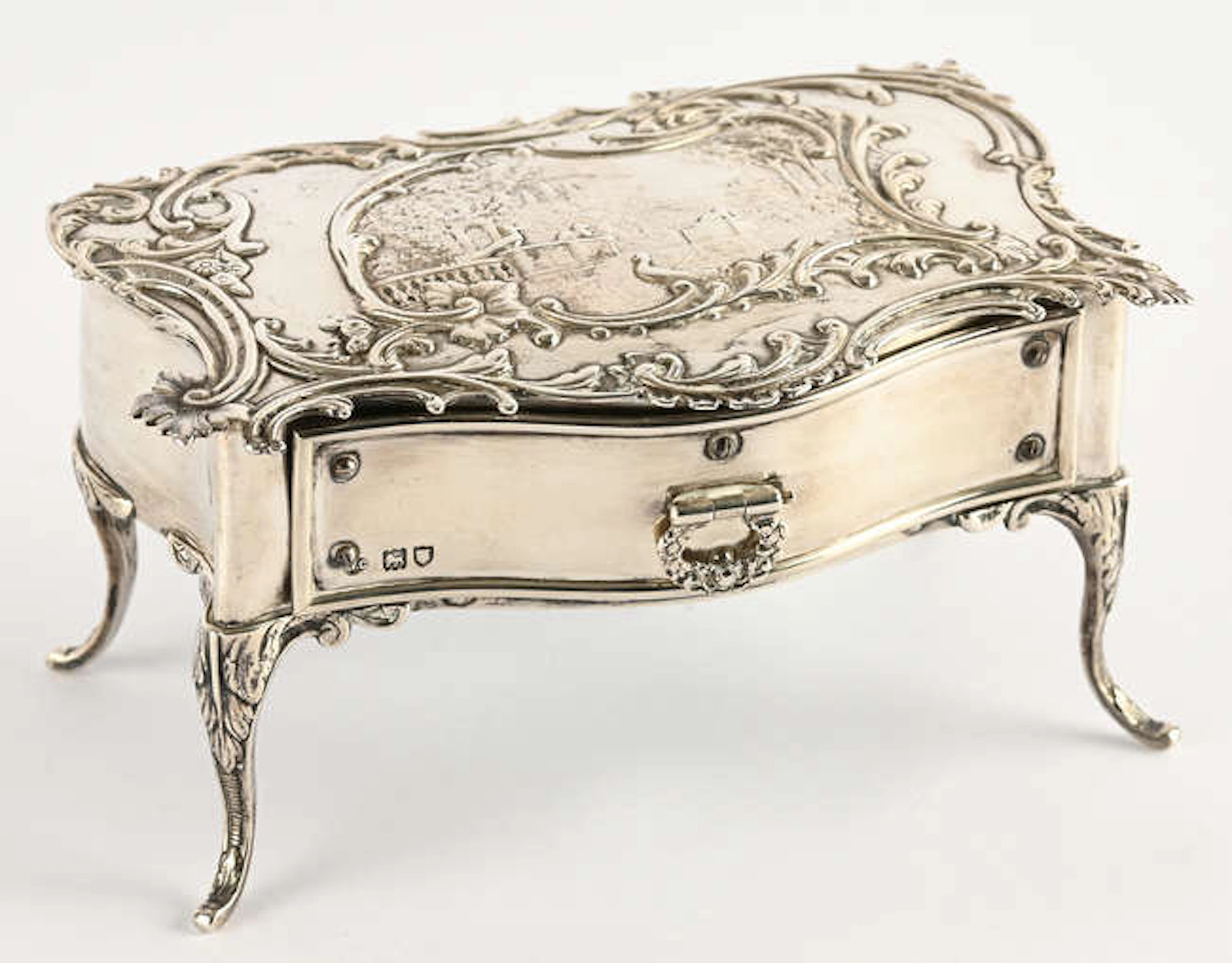 Miniature silver rococo table the top embossed with a vignette of