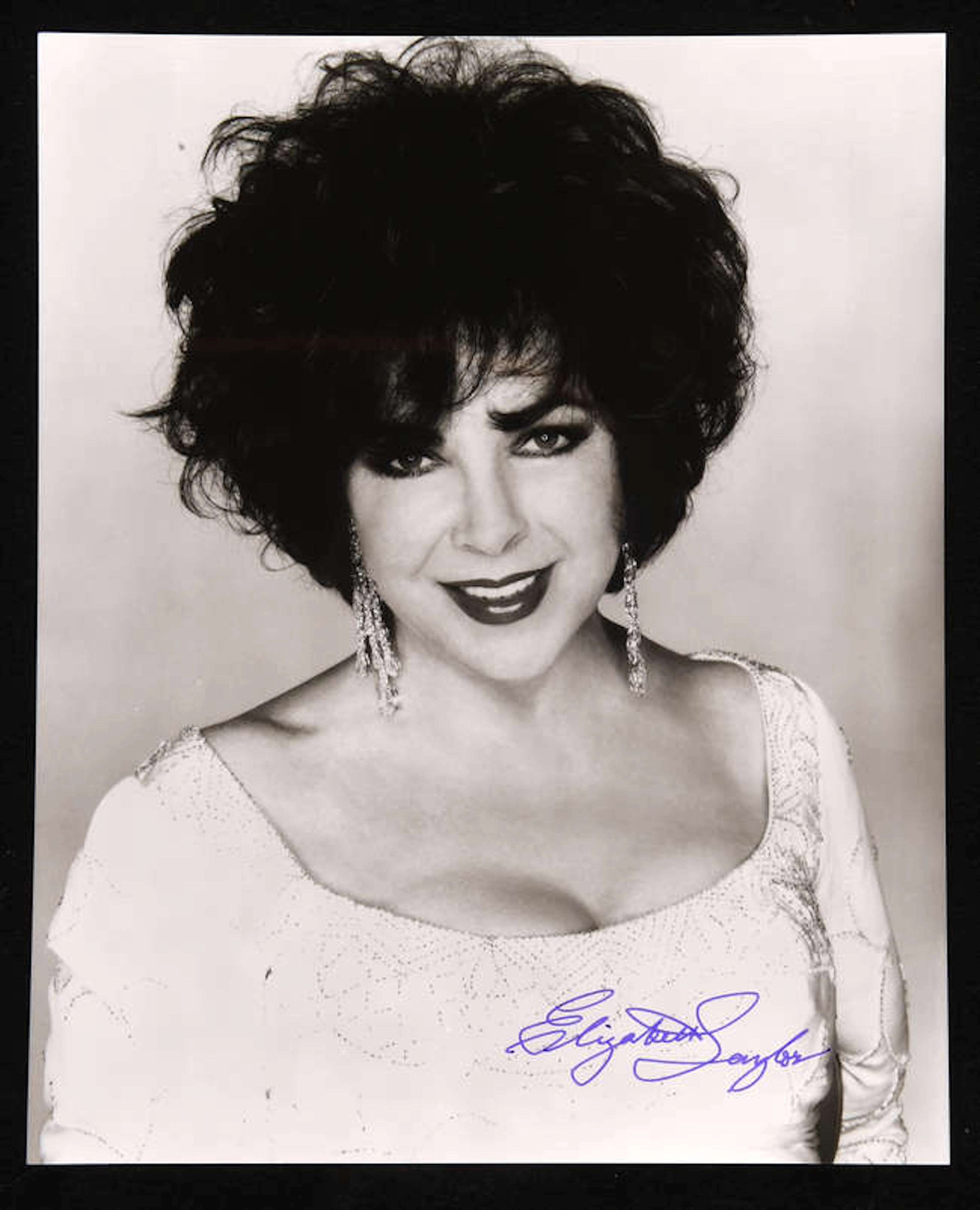 Elizabeth Taylor (1932-2011) Autographed publicity photograph black