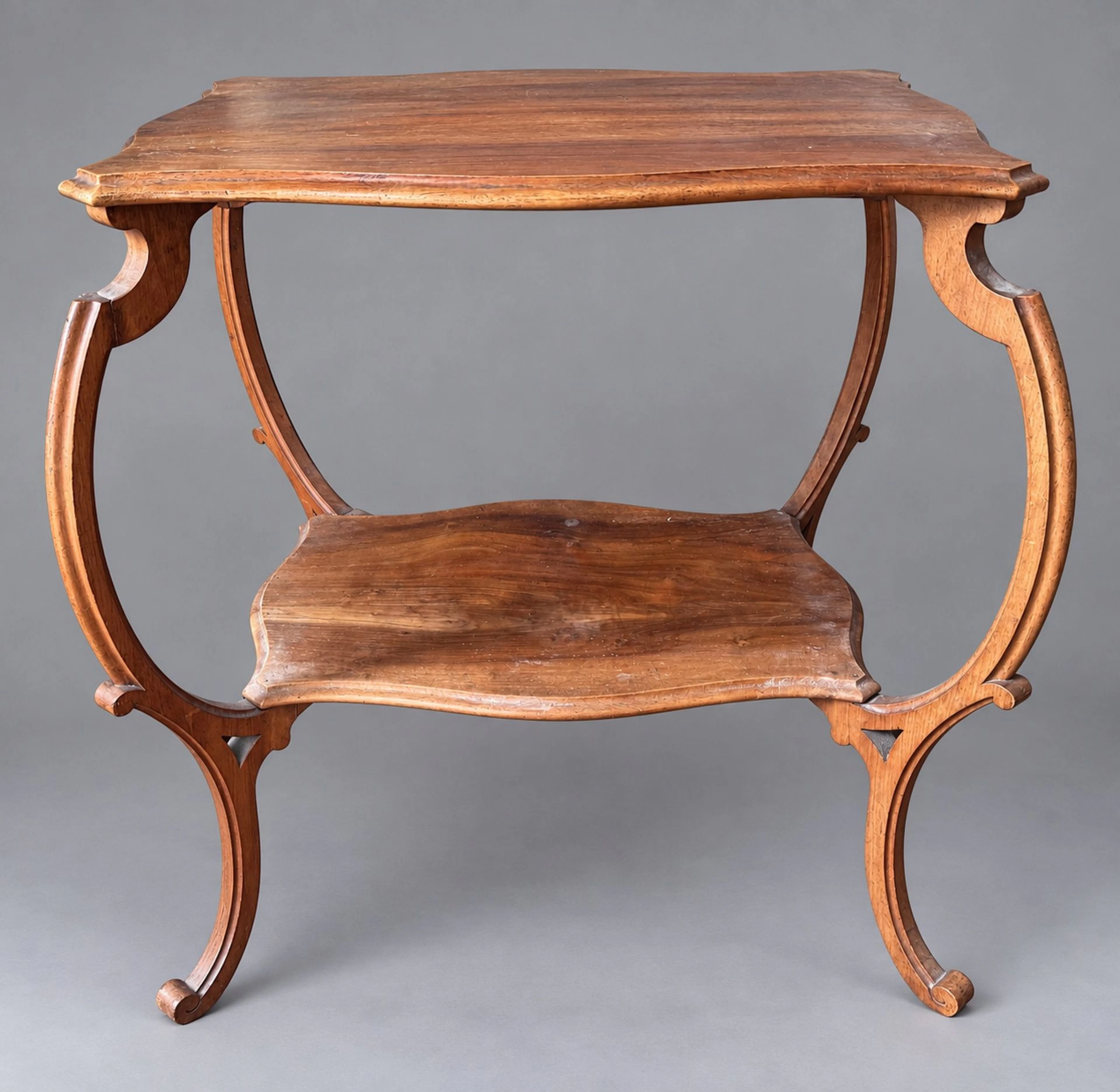 A freestanding table made of molded natural wood with two ir - Lot 257