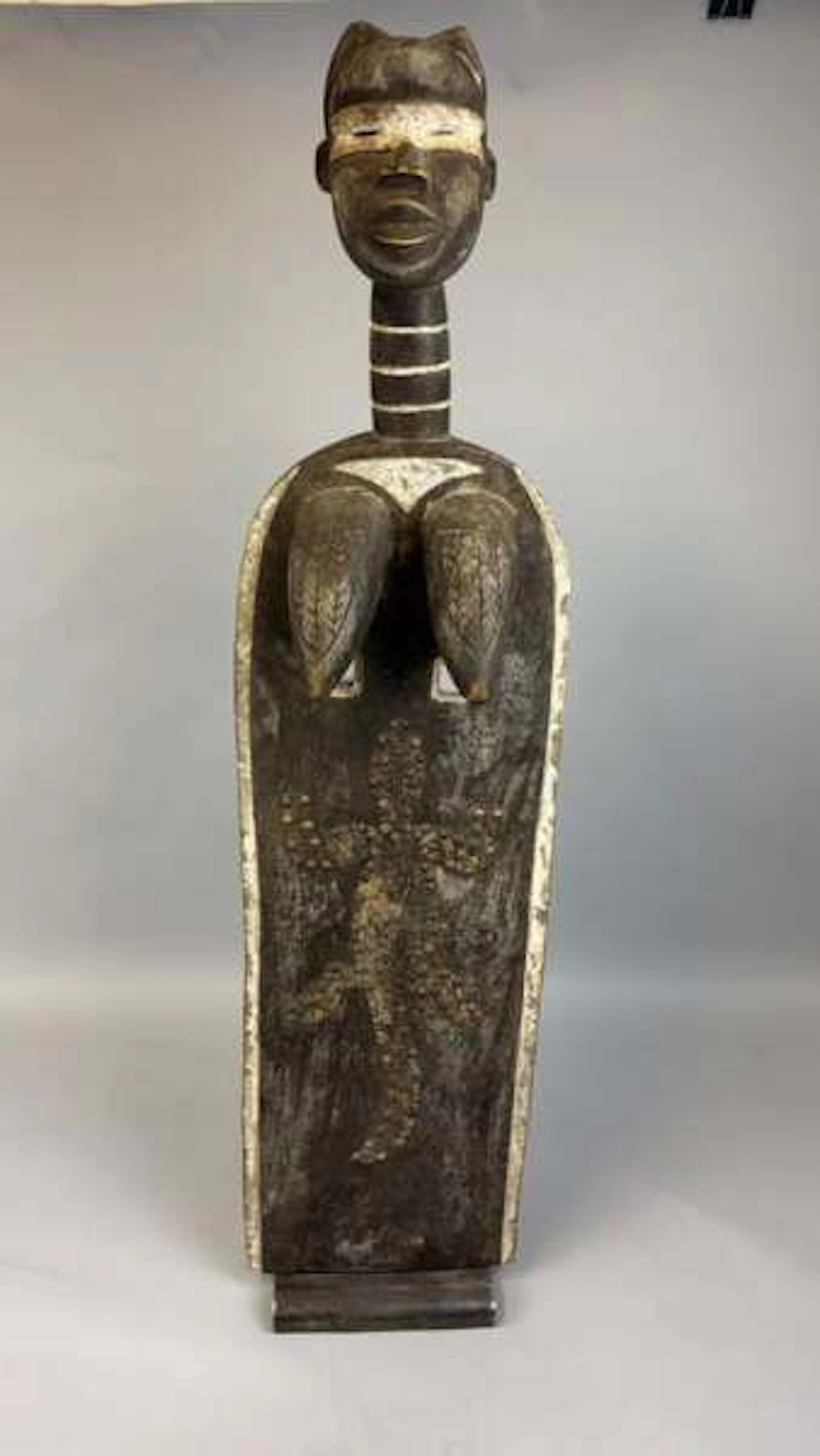 Carved wooden female mask with a dark patina and white highl - Lot 219