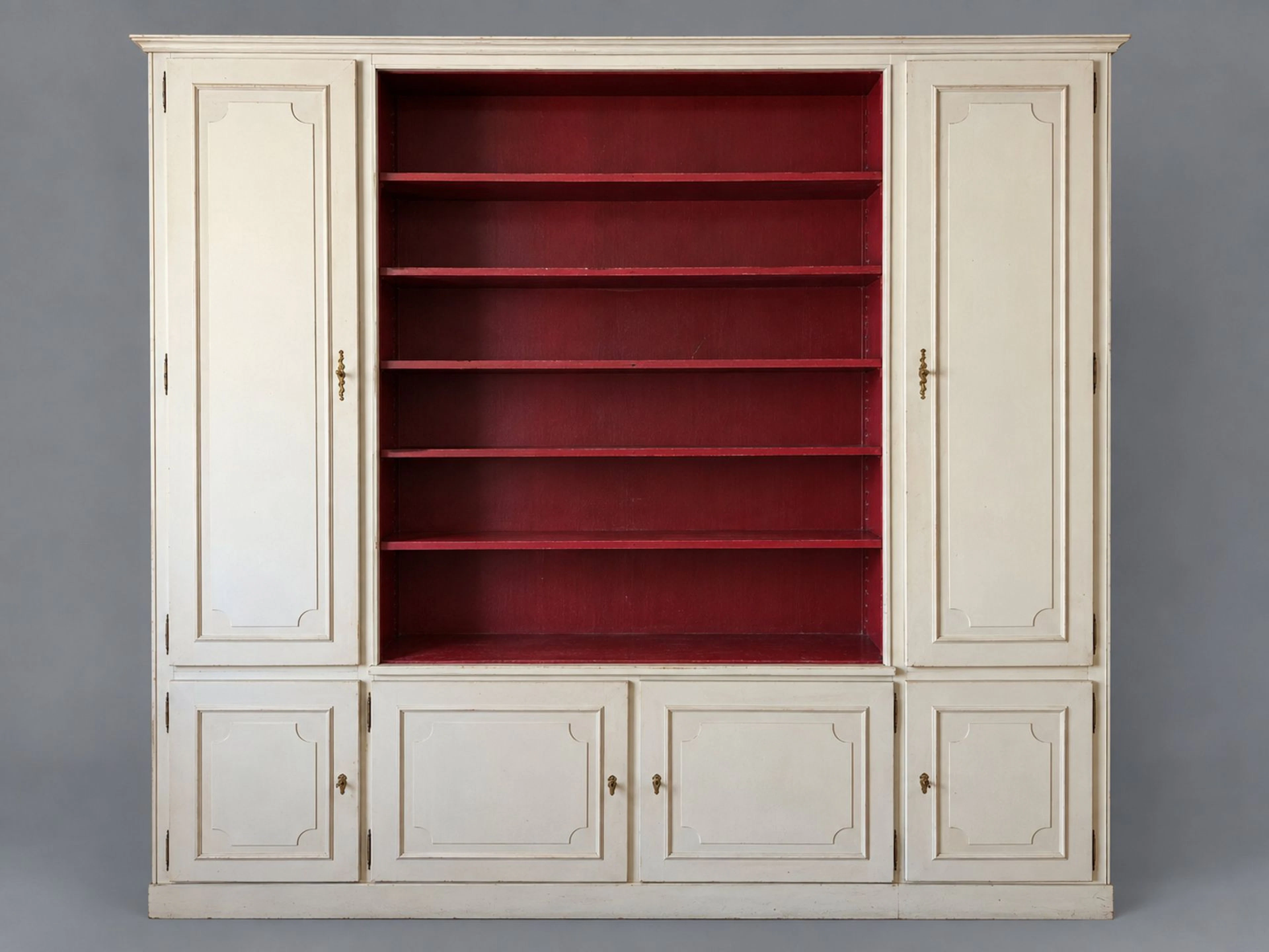 A large lacquered wooden bookcase featuring six molded doors - Lot 256