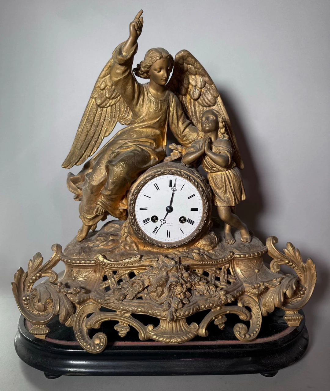 A gilded brass clock depicting a guardian angel and a child - Lot 233