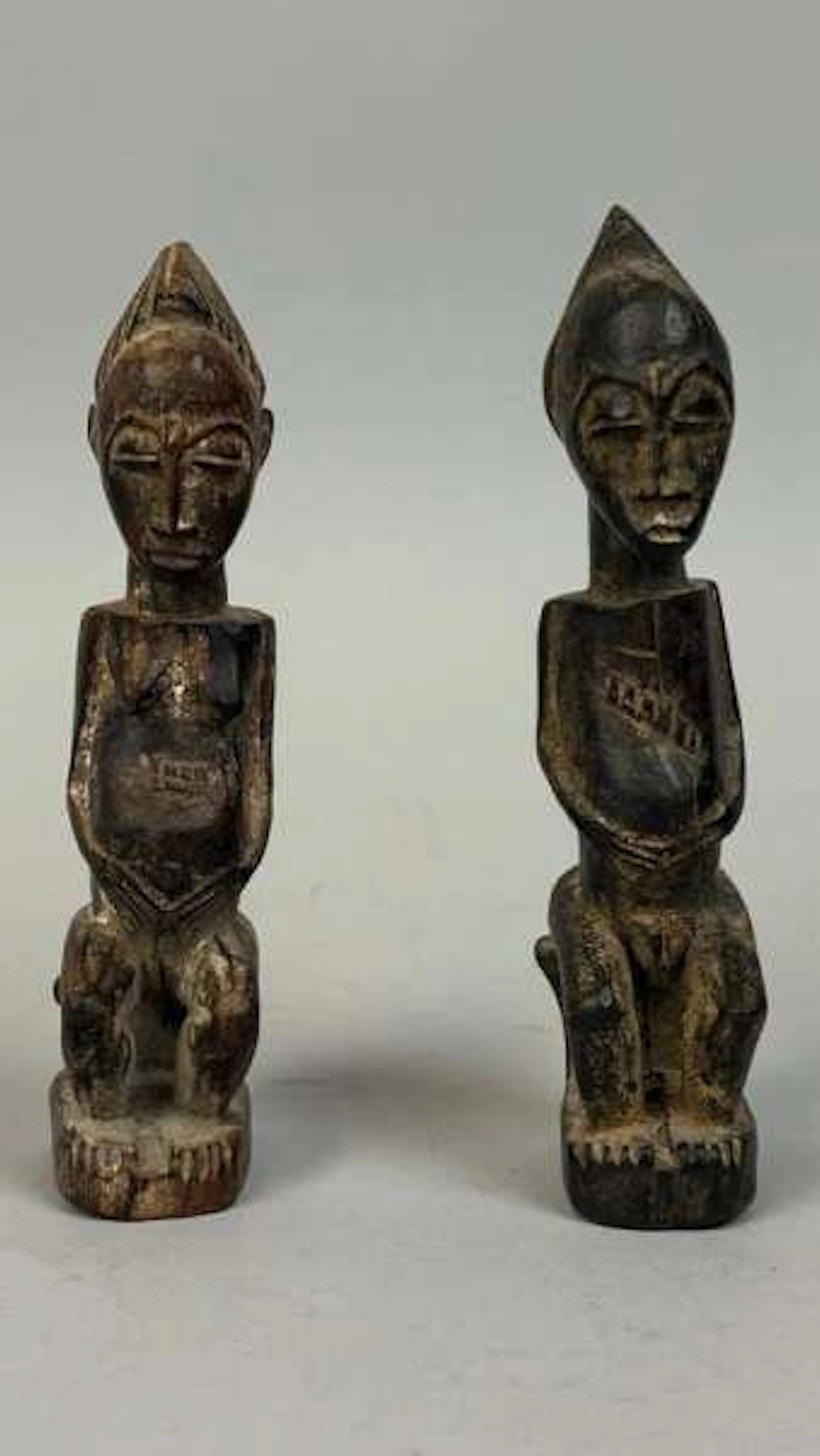 Pair of protective amulets carved from wood with a dark pati - Lot 218