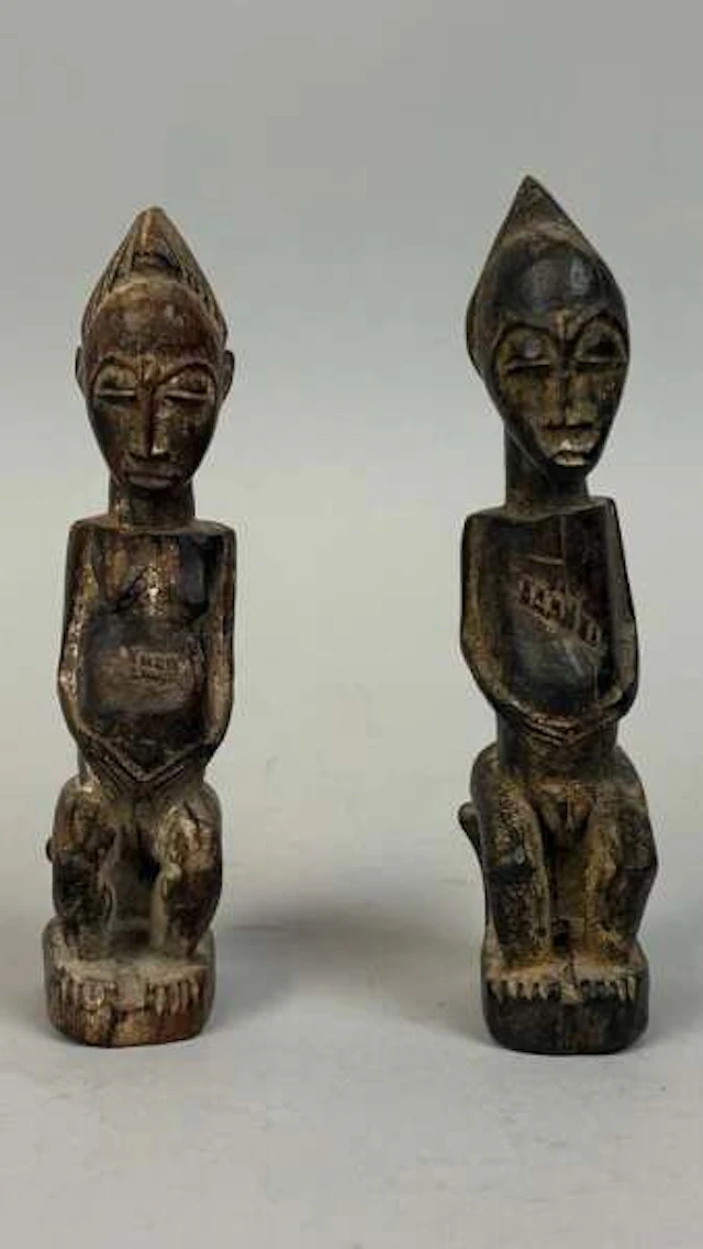 Pair of protective amulets carved from wood with a dark pati - Lot 218