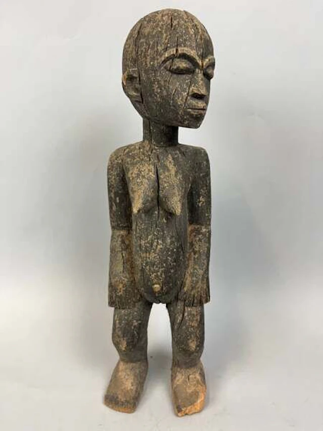 Carved wooden female statue with a dark, eroded, and crusty - Lot 215
