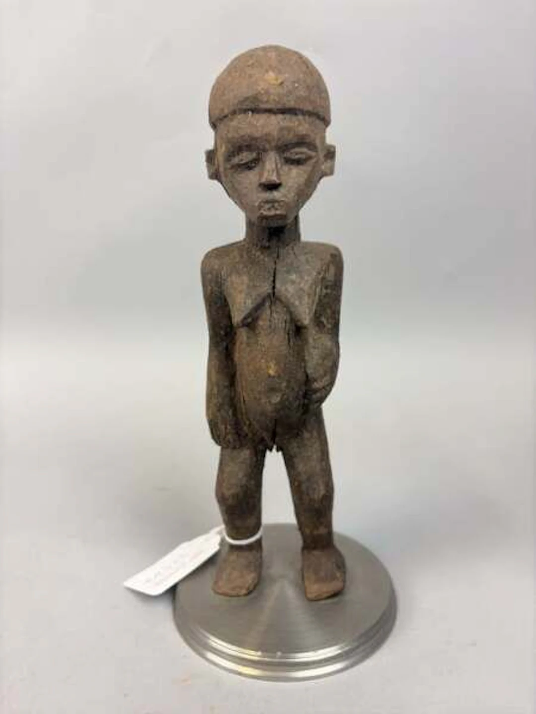 Carved wooden female figurine with a brown patina, depicted - Lot 237