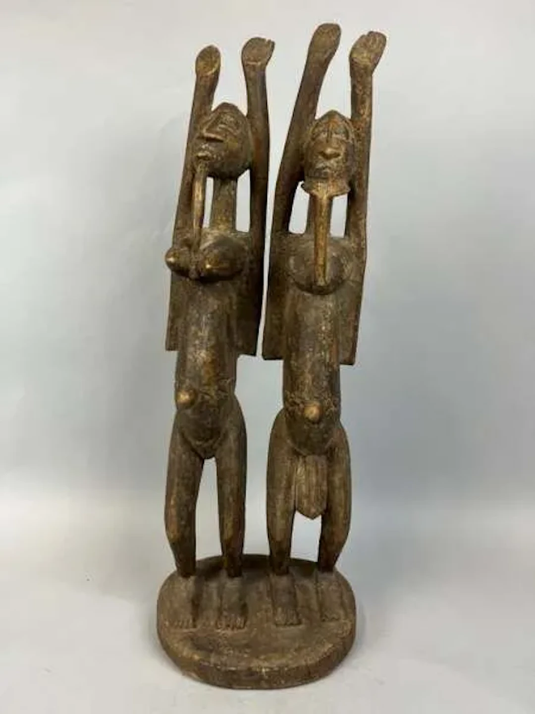 Carved wooden statue of a primordial couple with a brown pat - Lot 221