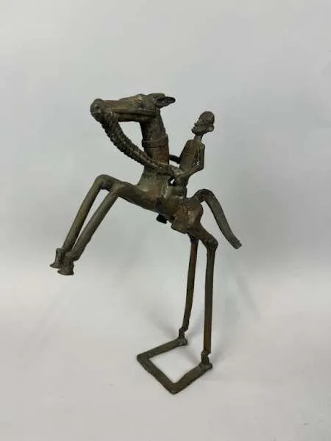 A copper alloy statuette with a dark patina, depicting a fig - Lot 231