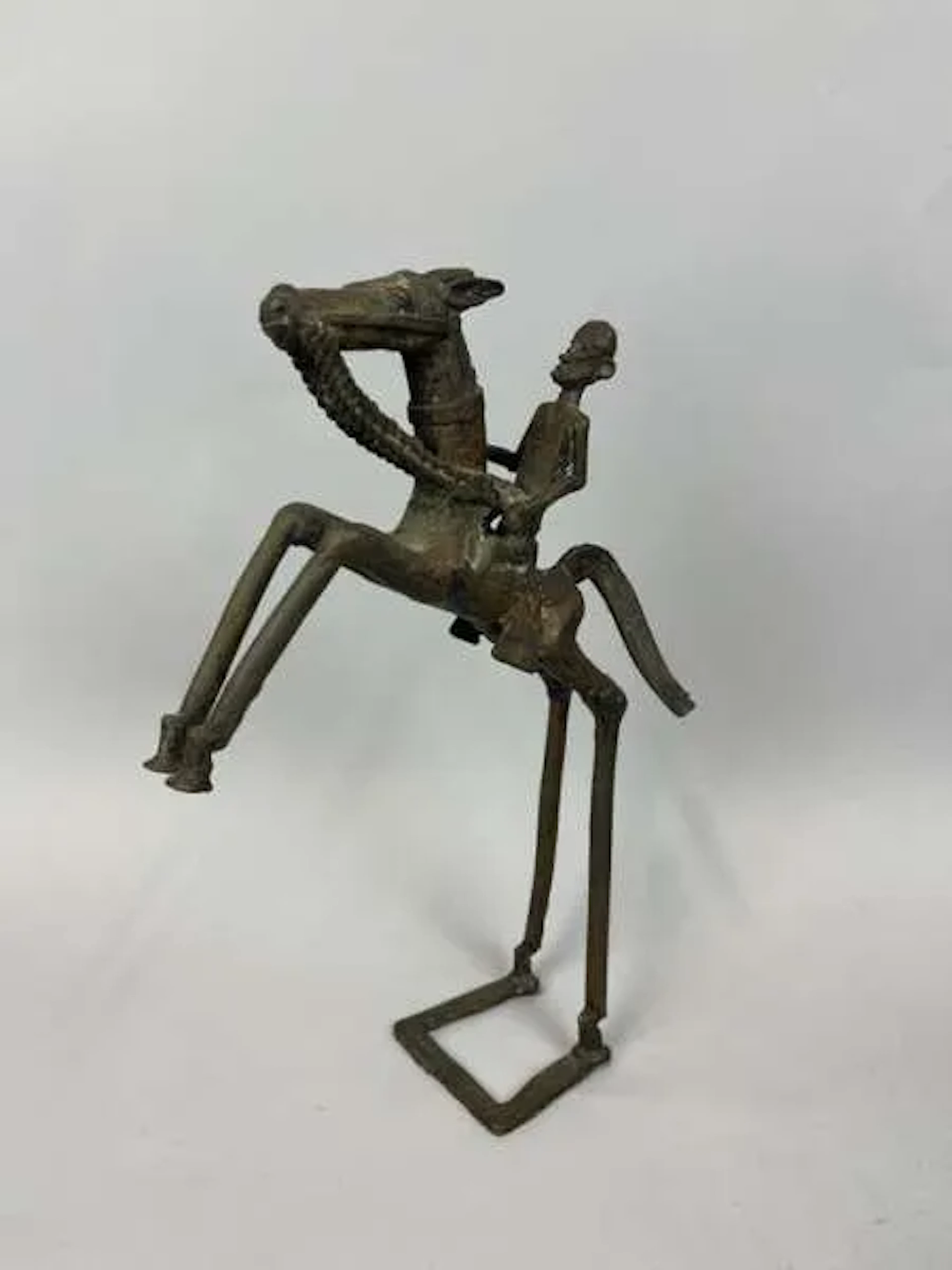 A copper alloy statuette with a dark patina, depicting a fig - Lot 231