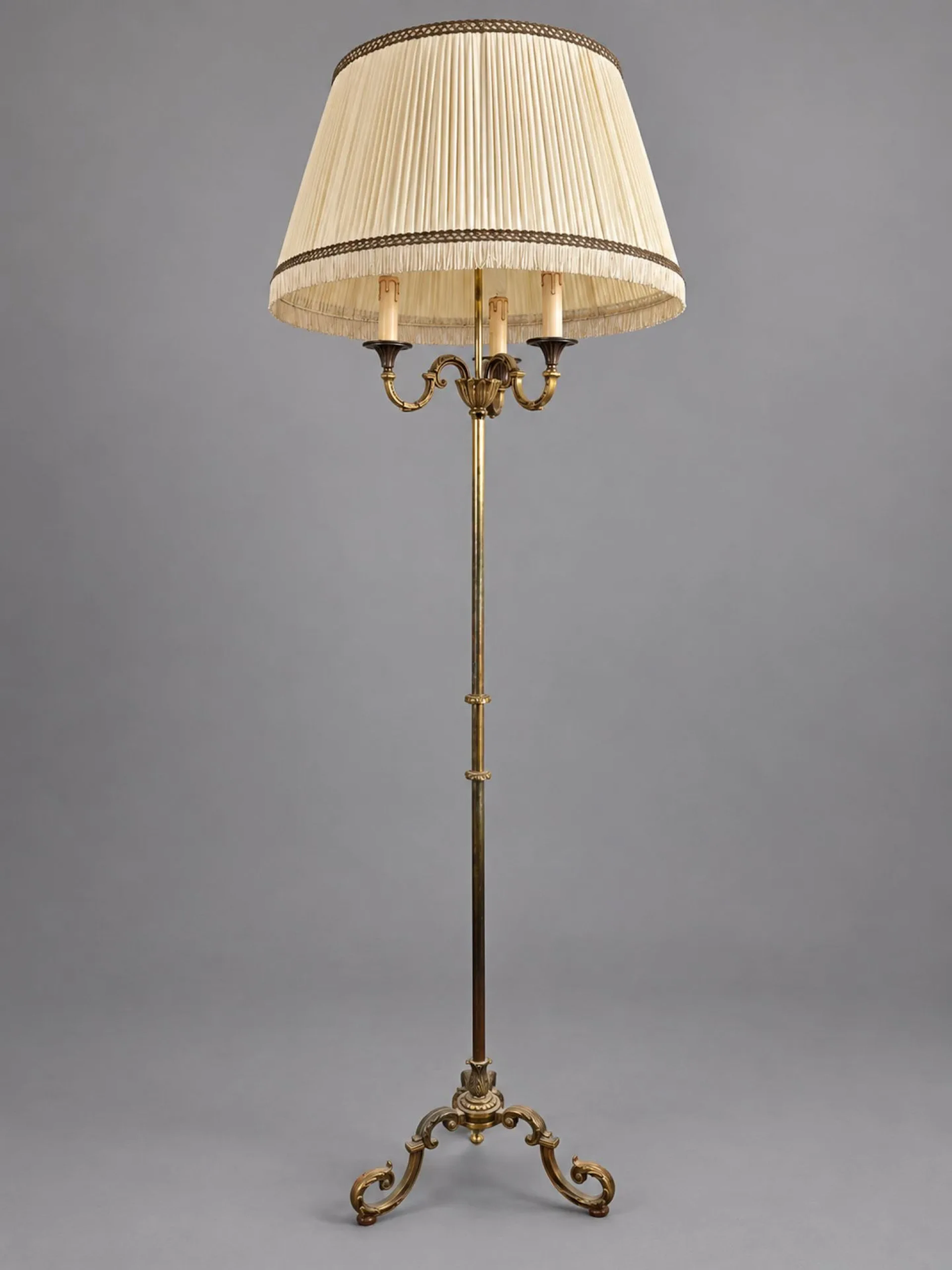 A gold-and-brass floor lamp with three sinuous arms and a st - Lot 245