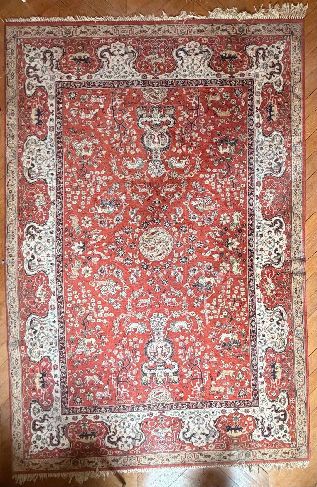 Wool rug with a red and ivory background featuring animal mo - Lot 288