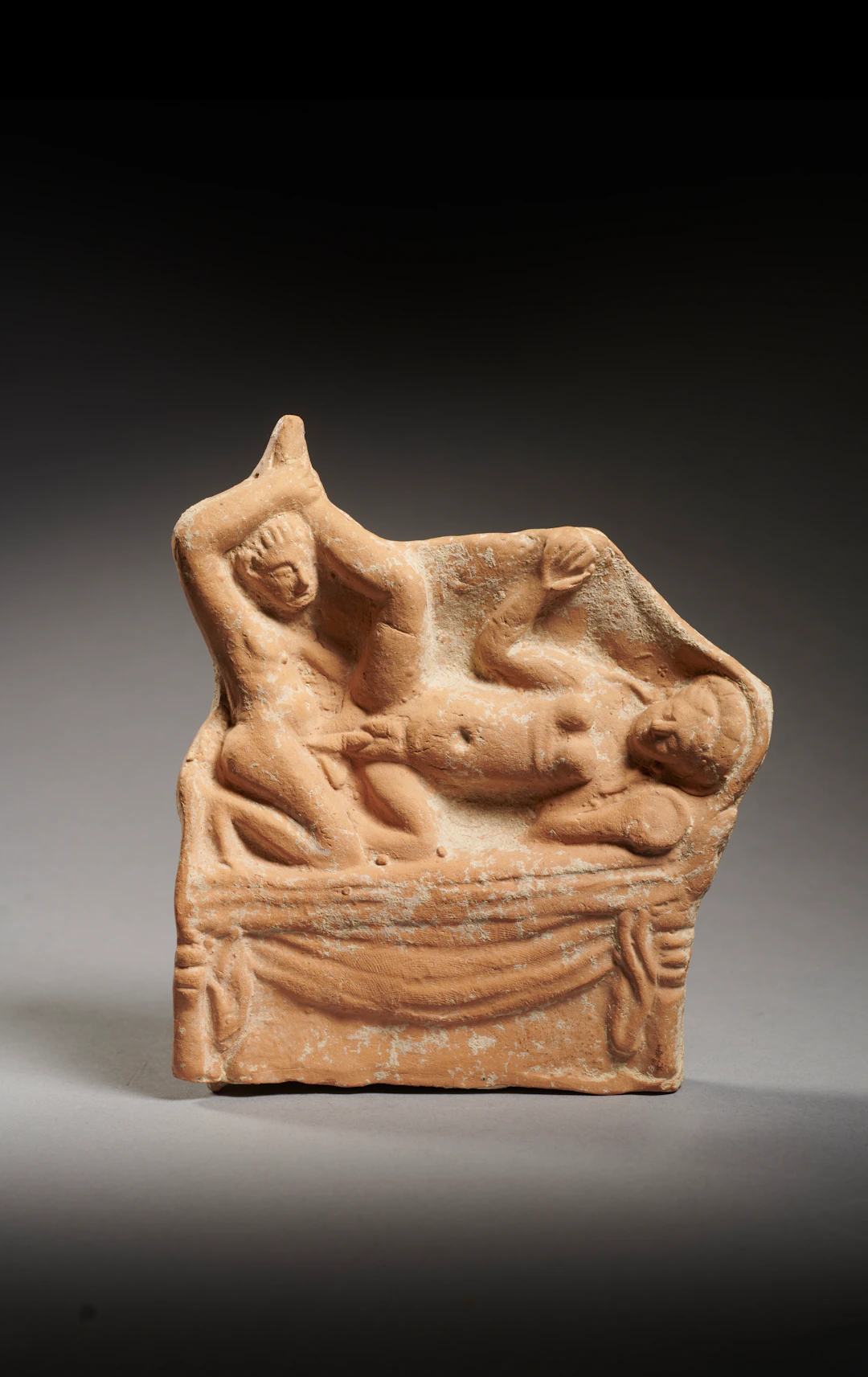 A Roman terracotta relief plaque with erotic scene